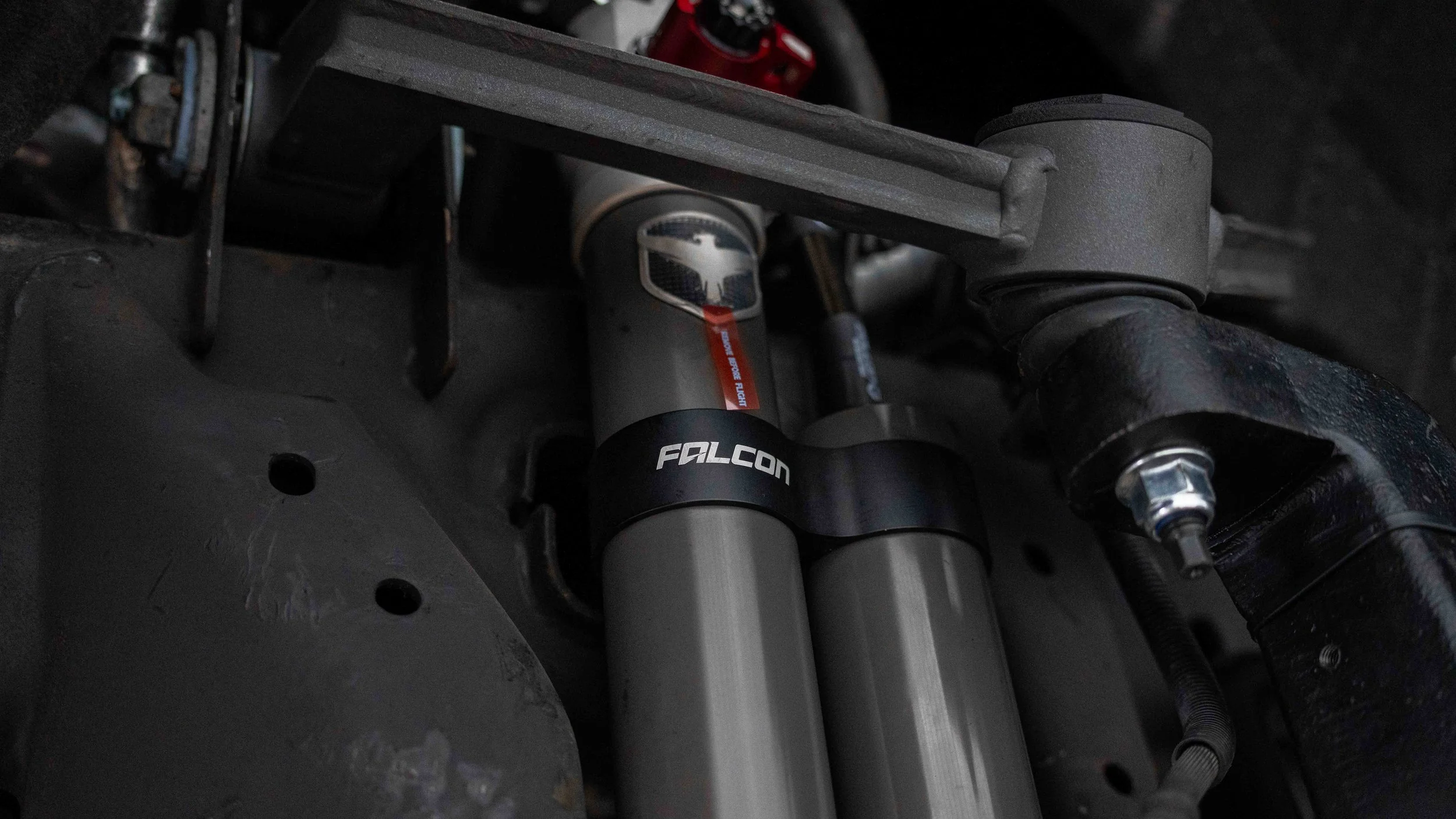 Falcon shock reservoirs mounted inside the wheel well during a ReadyLIFT GMC Sierra suspension lift installation.