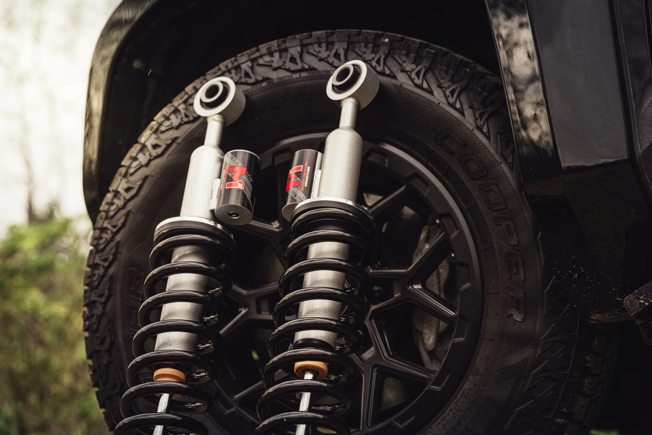 Rough Country M1R Reservoir loaded struts installed on a lifted truck with Cooper all-terrain tires at Xtreme Car and Truck Accessories in Bridgeville, PA.