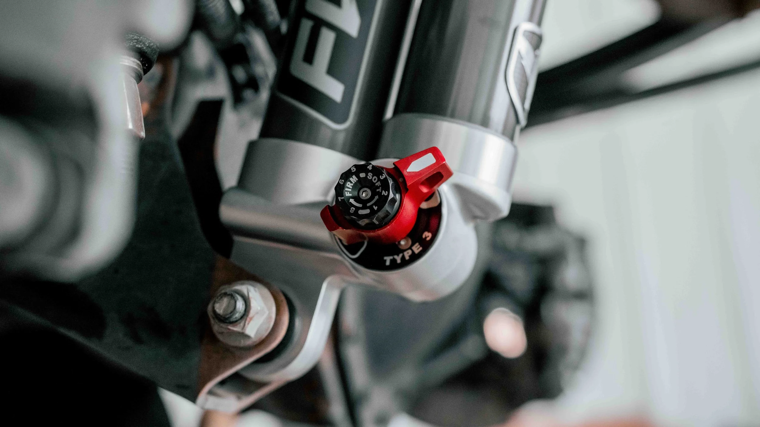 Close-up of Falcon 3.3 shock adjustment dial on a ReadyLIFT GMC Sierra suspension lift installation.