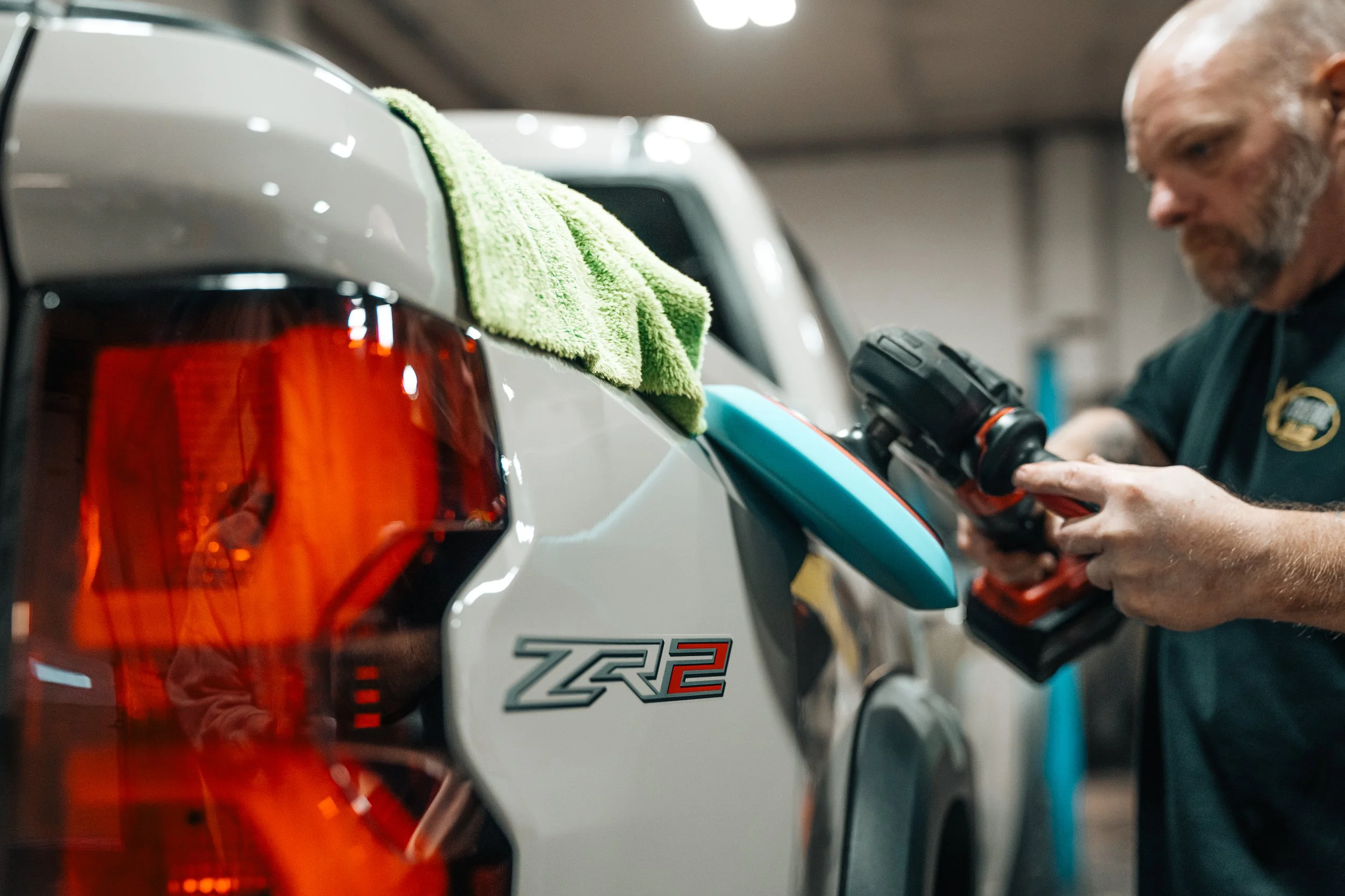 Technician polishing a truck during auto detailing while applying XPEL TST Paint Protection for a glossy, durable finish at Xtreme Car & Truck Accessories in Bridgeville, PA.