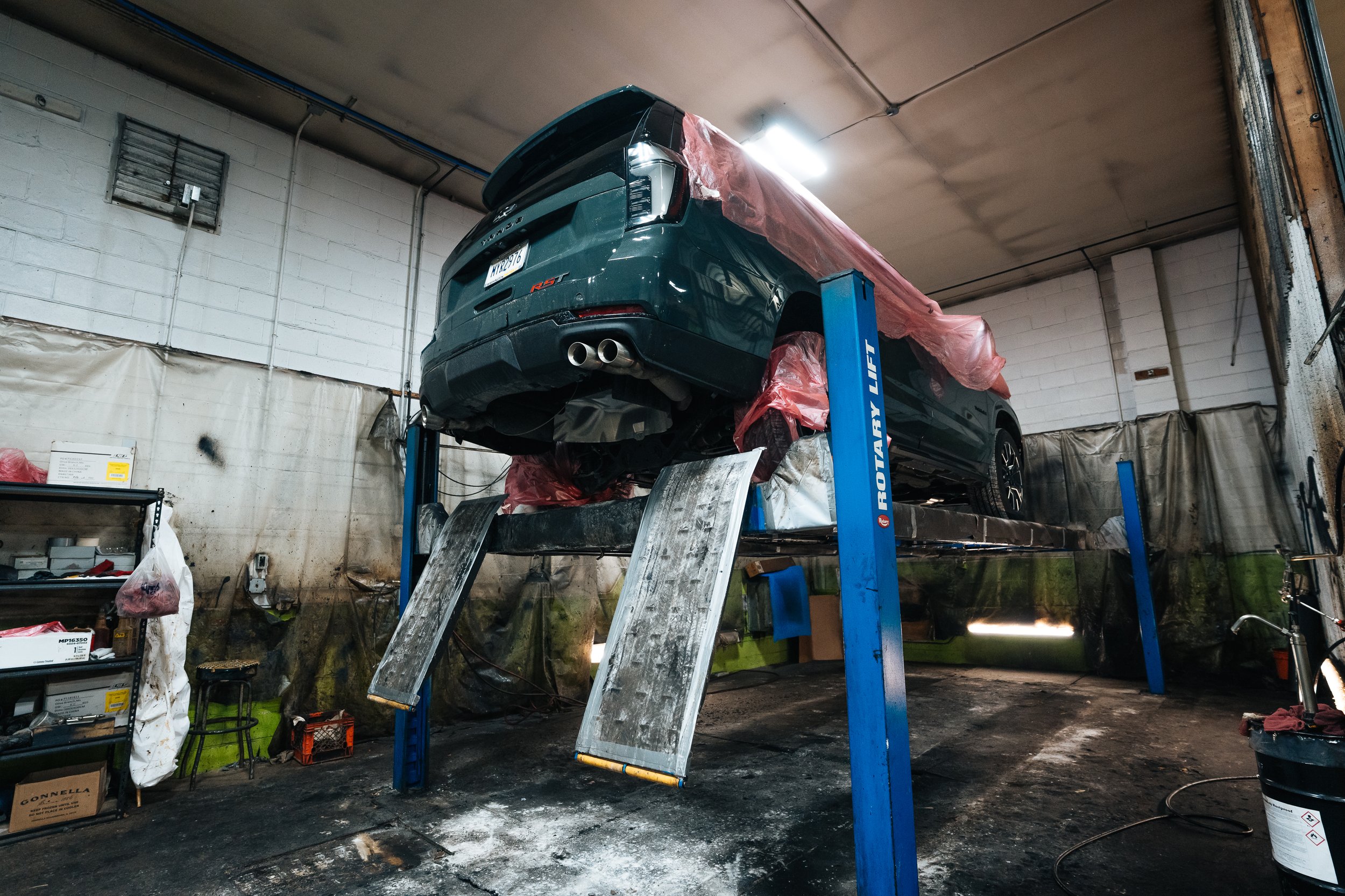 Vehicle masked and lifted for undercoating and rustproofing service in Bridgeville near Pittsburgh, PA