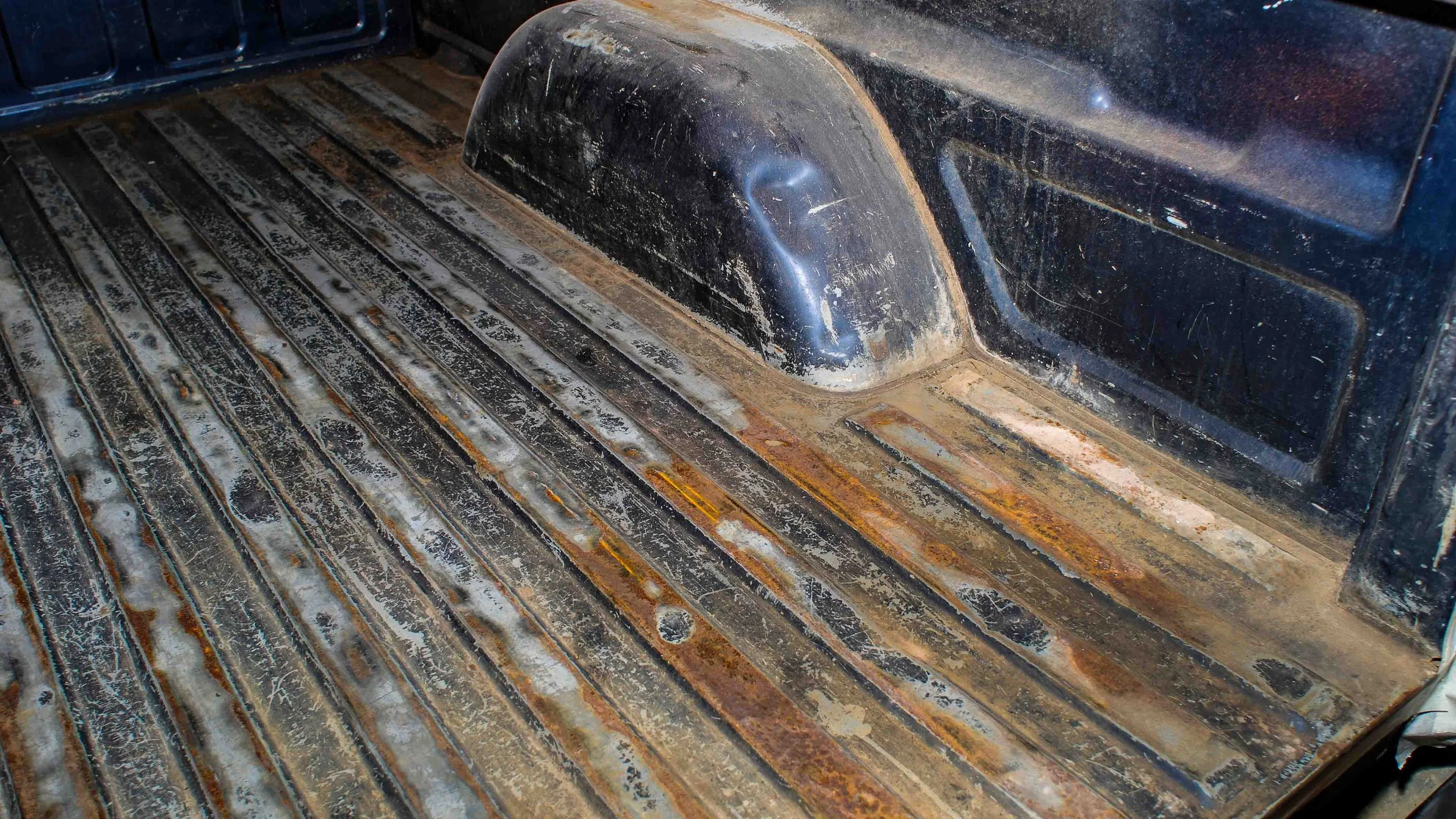 Damaged truck bed with rust, corrosion, and worn paint after a traditional drop-in bed liner was removed, showing why truck owners in Bridgeville and Pittsburgh choose professional spray-in bed liners from Xtreme Car & Truck Accessories.