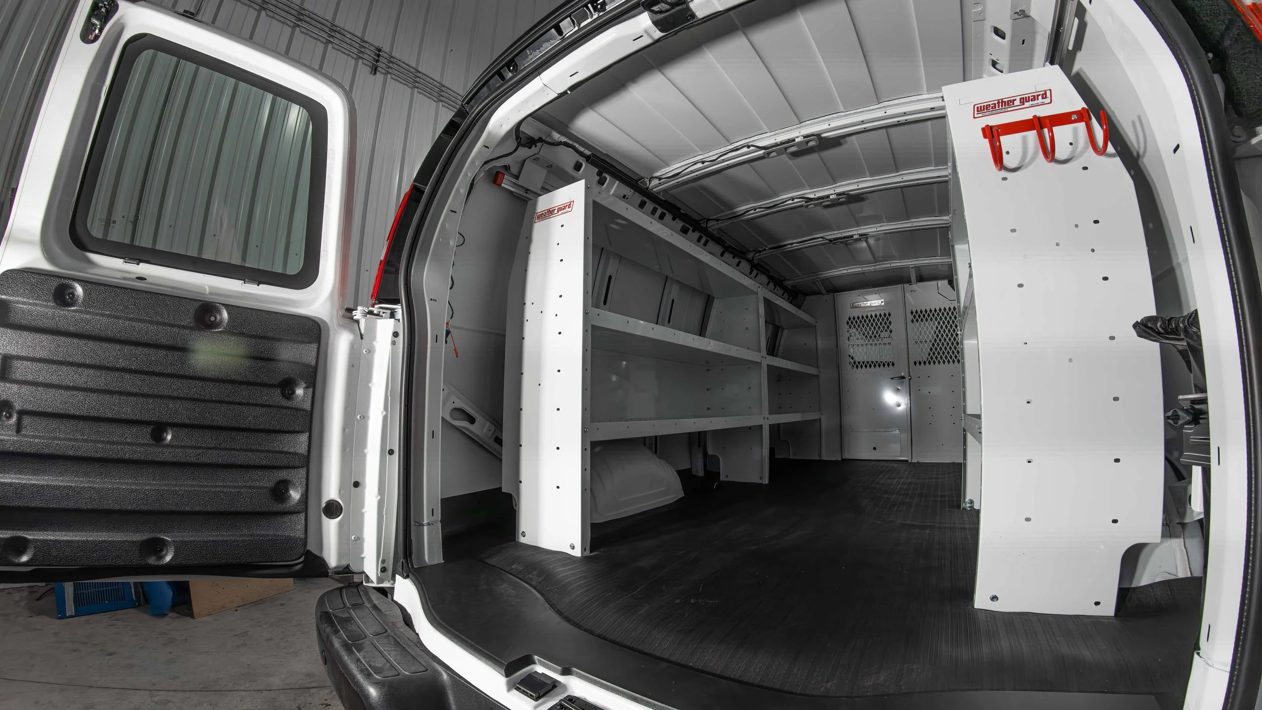 Wide rear view into a Chevy Express cargo van after a WeatherGuard van shelving install at Xtreme Car and Truck Accessories near Pittsburgh