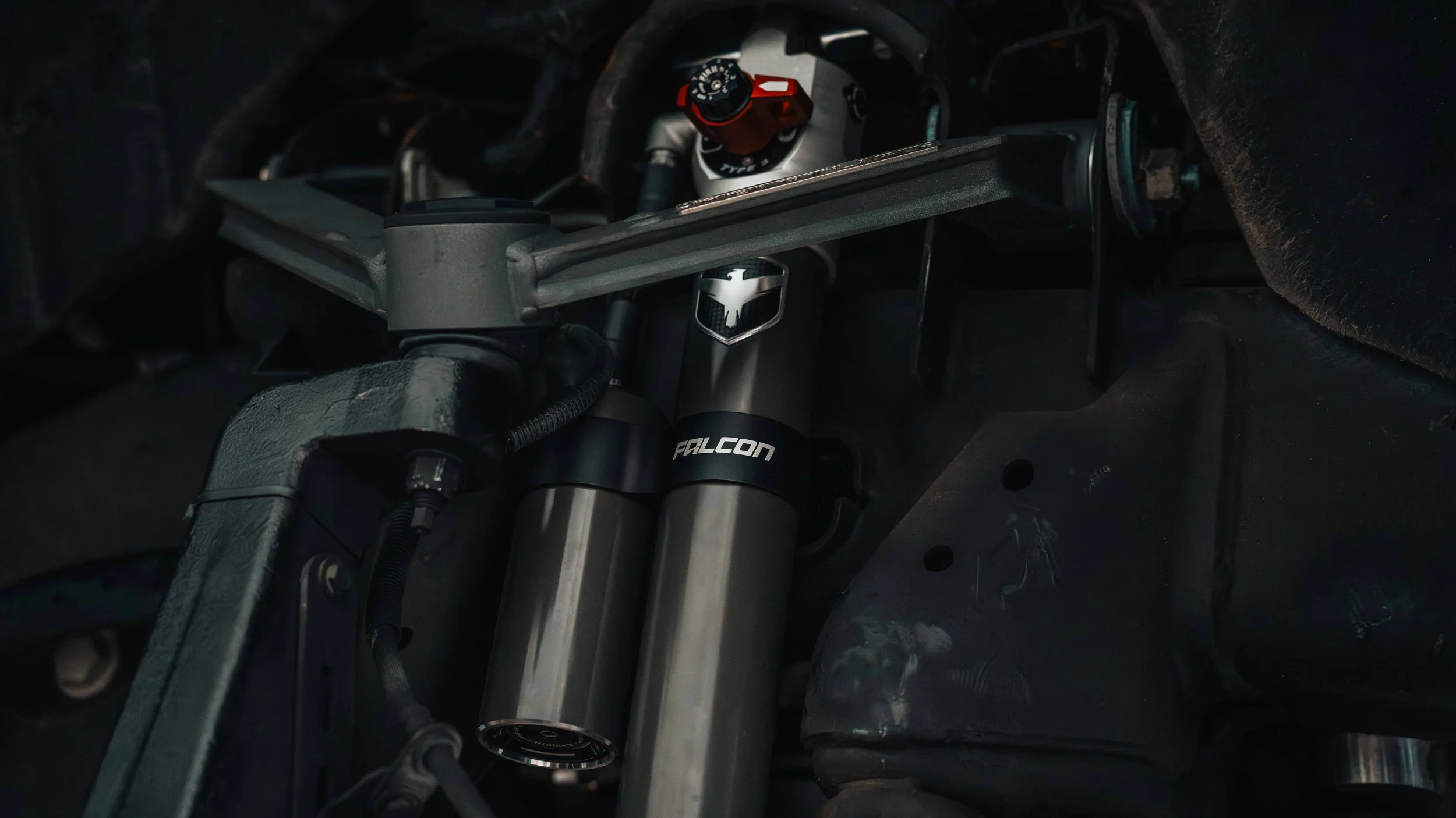 Falcon shock and ReadyLIFT suspension components installed inside the wheel well of a GMC Sierra lift kit build.