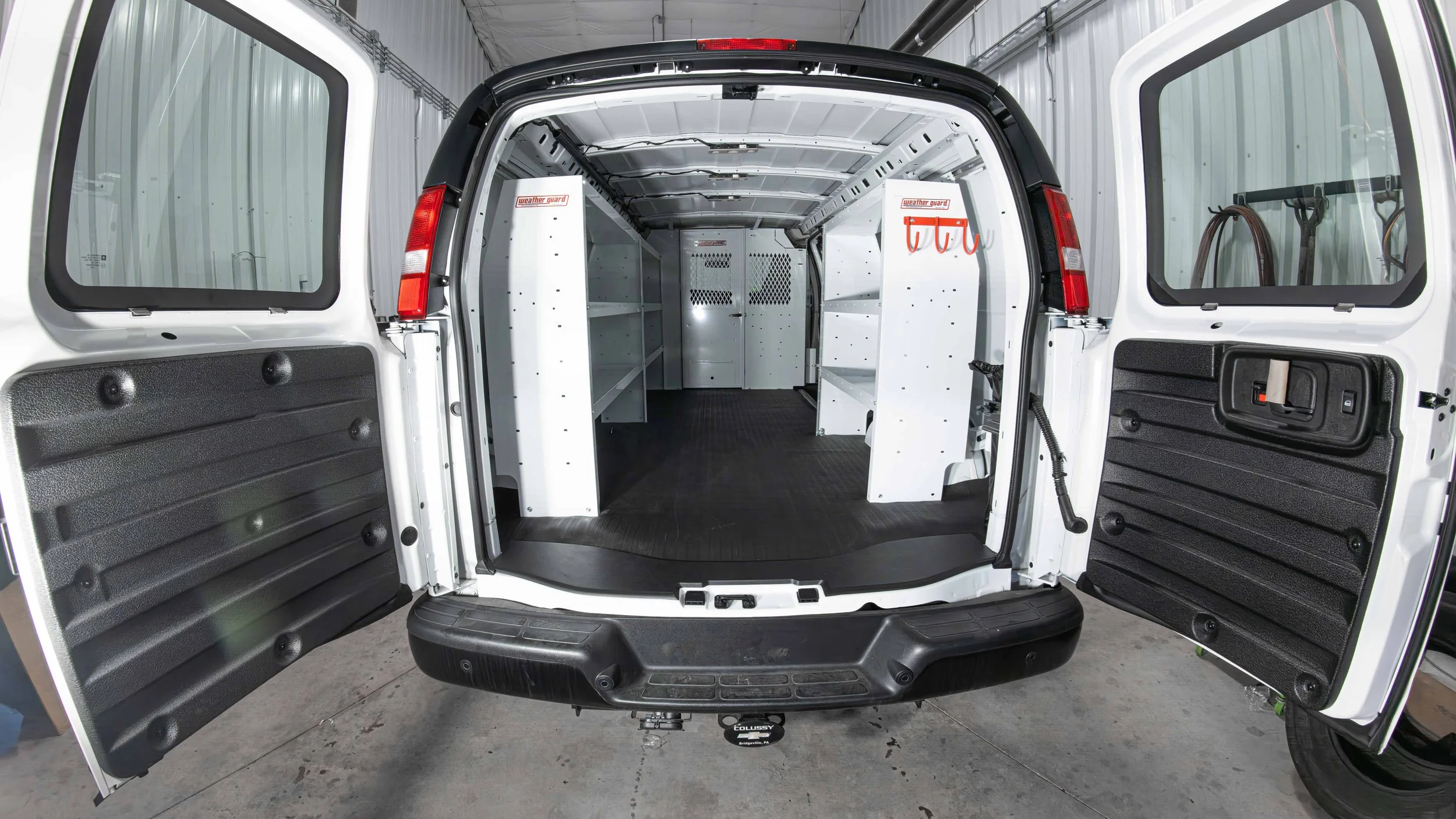 Rear view of a Chevy Express cargo van with WeatherGuard steel shelving installed down both sides by Xtreme Car and Truck Accessories in Bridgeville, PA