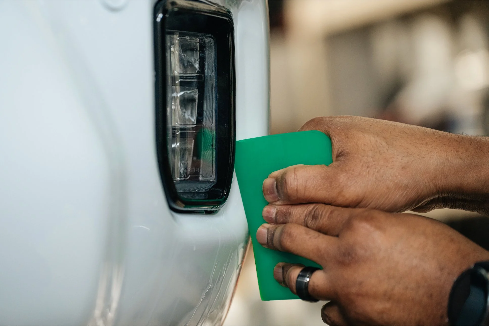Technician installing XEL paint protection film (PPF) on the front fender of a truck at Xtreme Car & Truck Accessories.