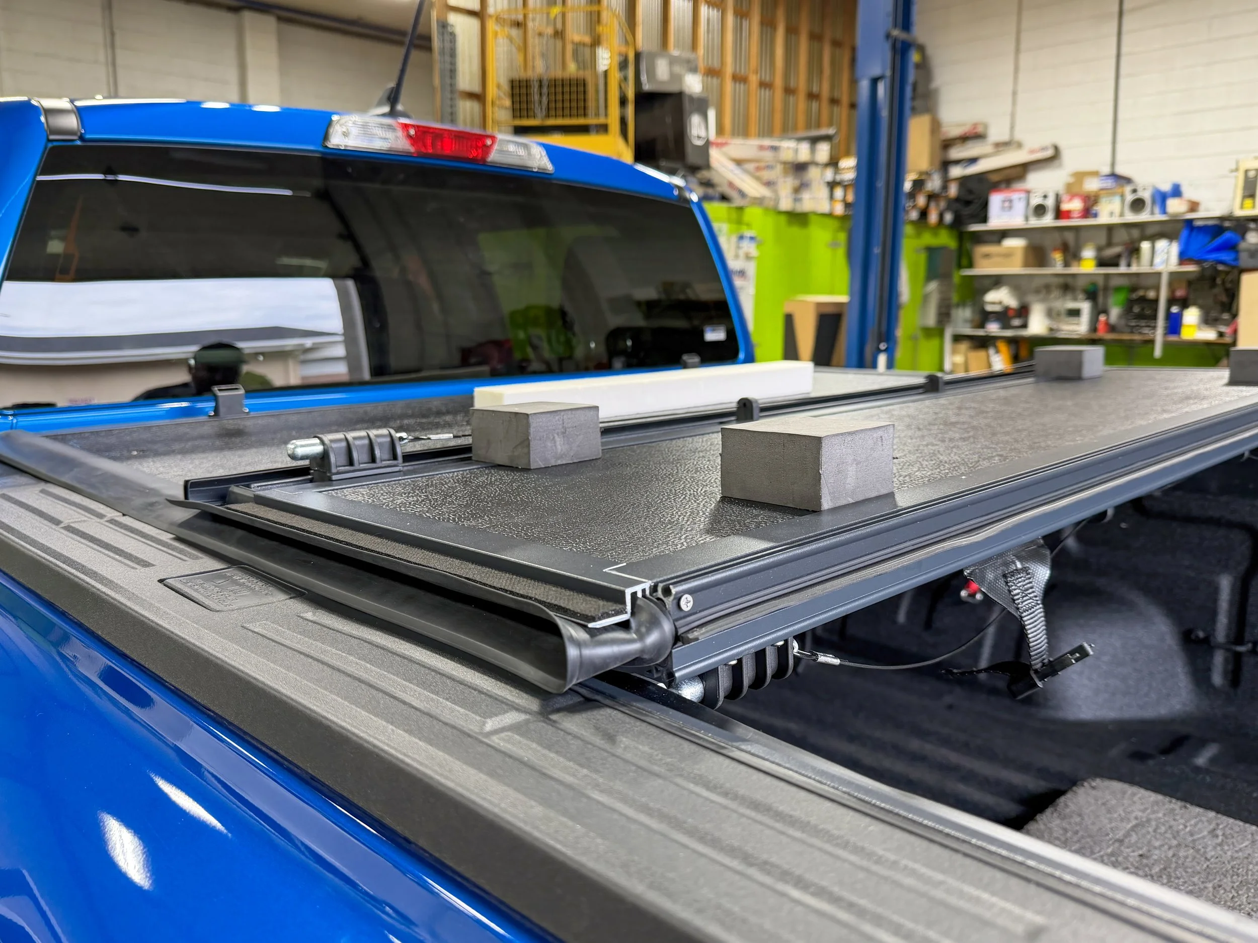 Rough Country hard tonneau cover installation on a pickup truck at Xtreme Car & Truck Accessories in Bridgeville, PA