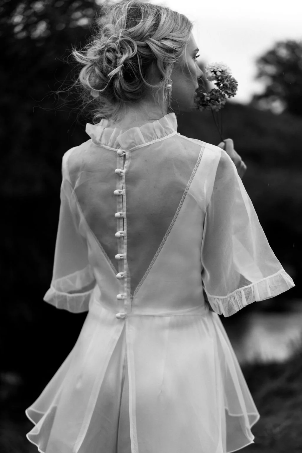 A professional makeup artist working in North Yorkshire, creating soft, natural bridal makeup. Close-up of glowing, dewy skin, warm rose blush, subtle neutral eyeshadow with fine shimmer, softly defined lashes, and a fresh nude-pink lip. 