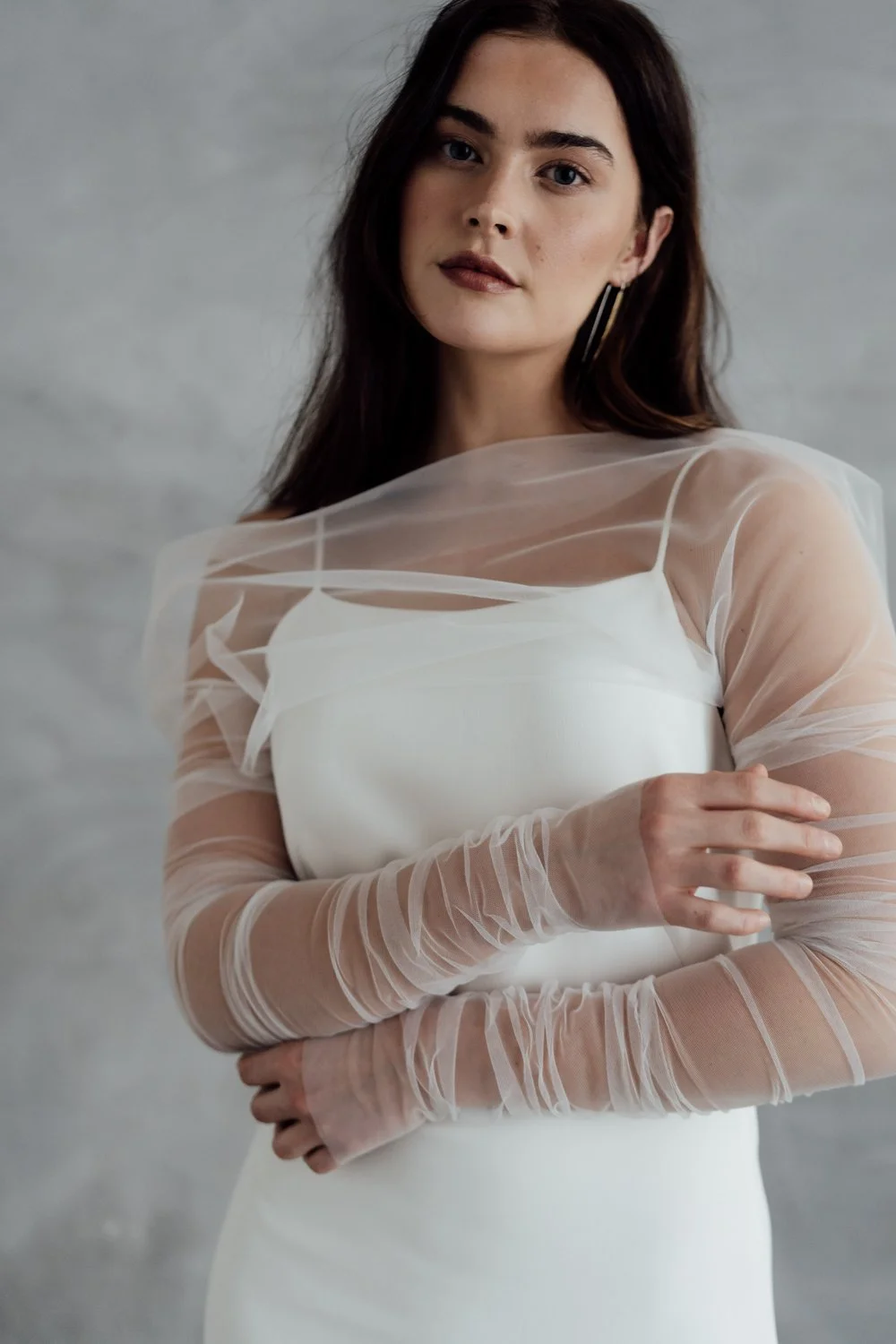 A professional makeup artist working in North Yorkshire, creating soft, natural bridal makeup. Close-up of glowing, dewy skin, warm rose blush, subtle neutral eyeshadow with fine shimmer, softly defined lashes, and a fresh nude-pink lip. 