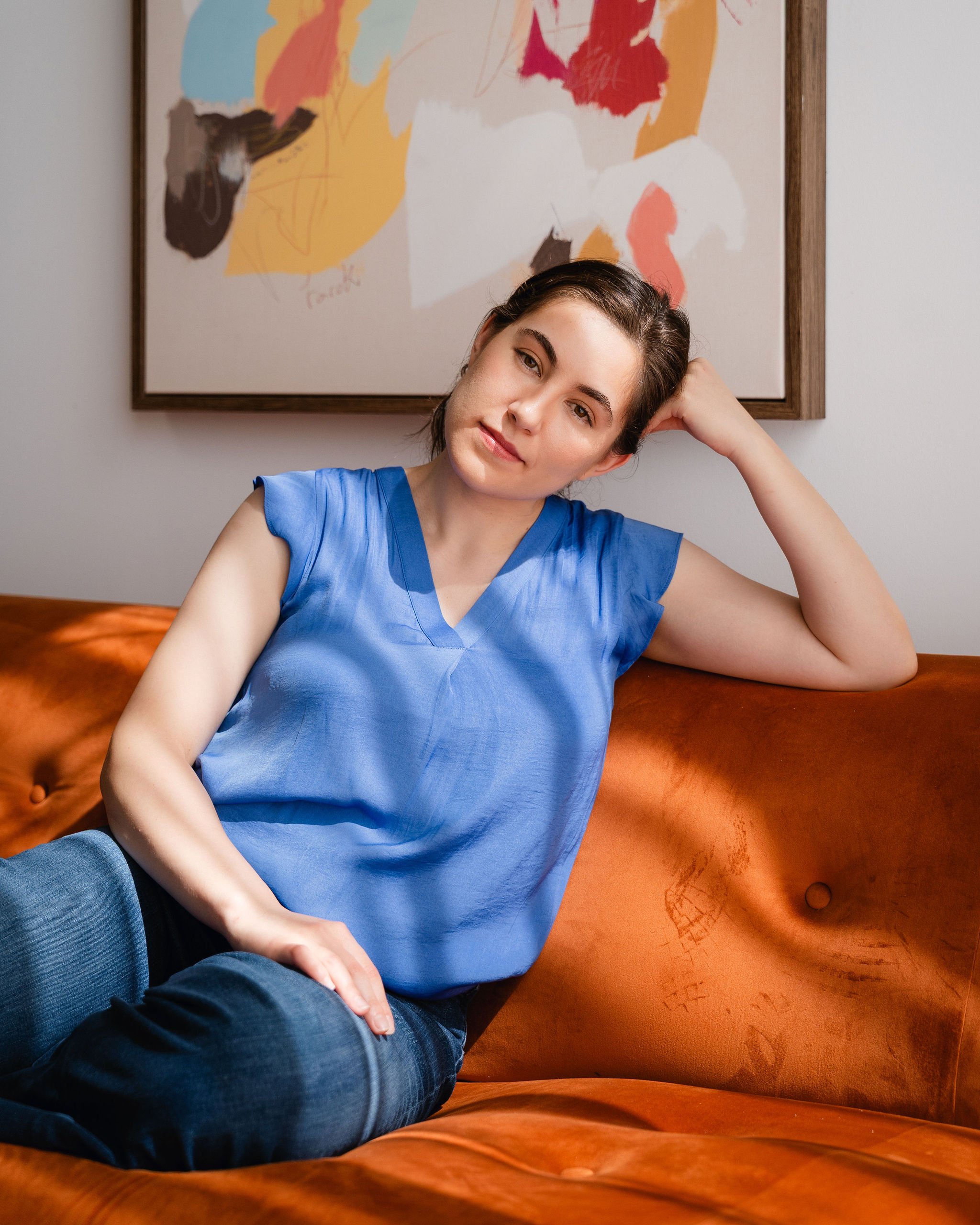 Monauar looking at the camera with her head resting on her hand