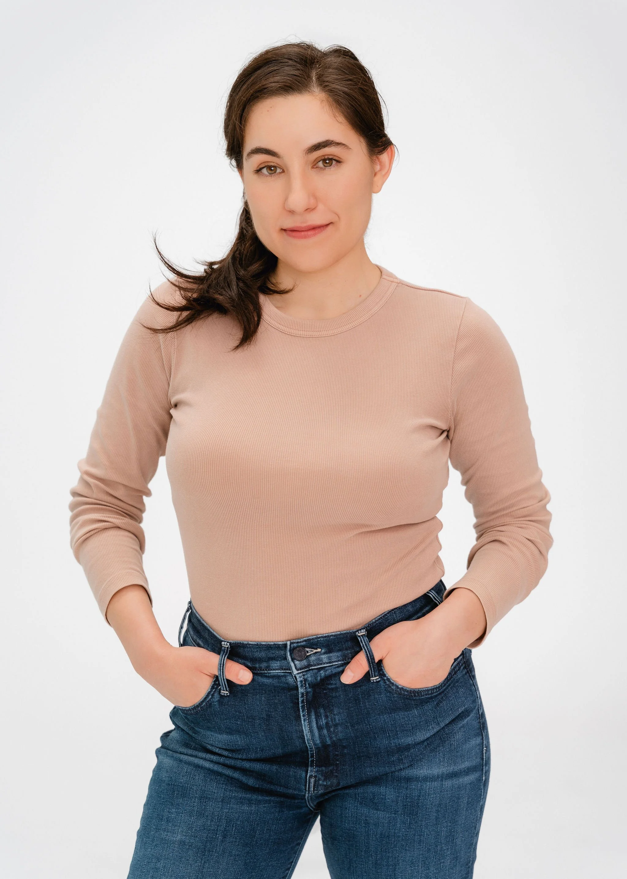 Monauar looking at the camera with hands in her pockets