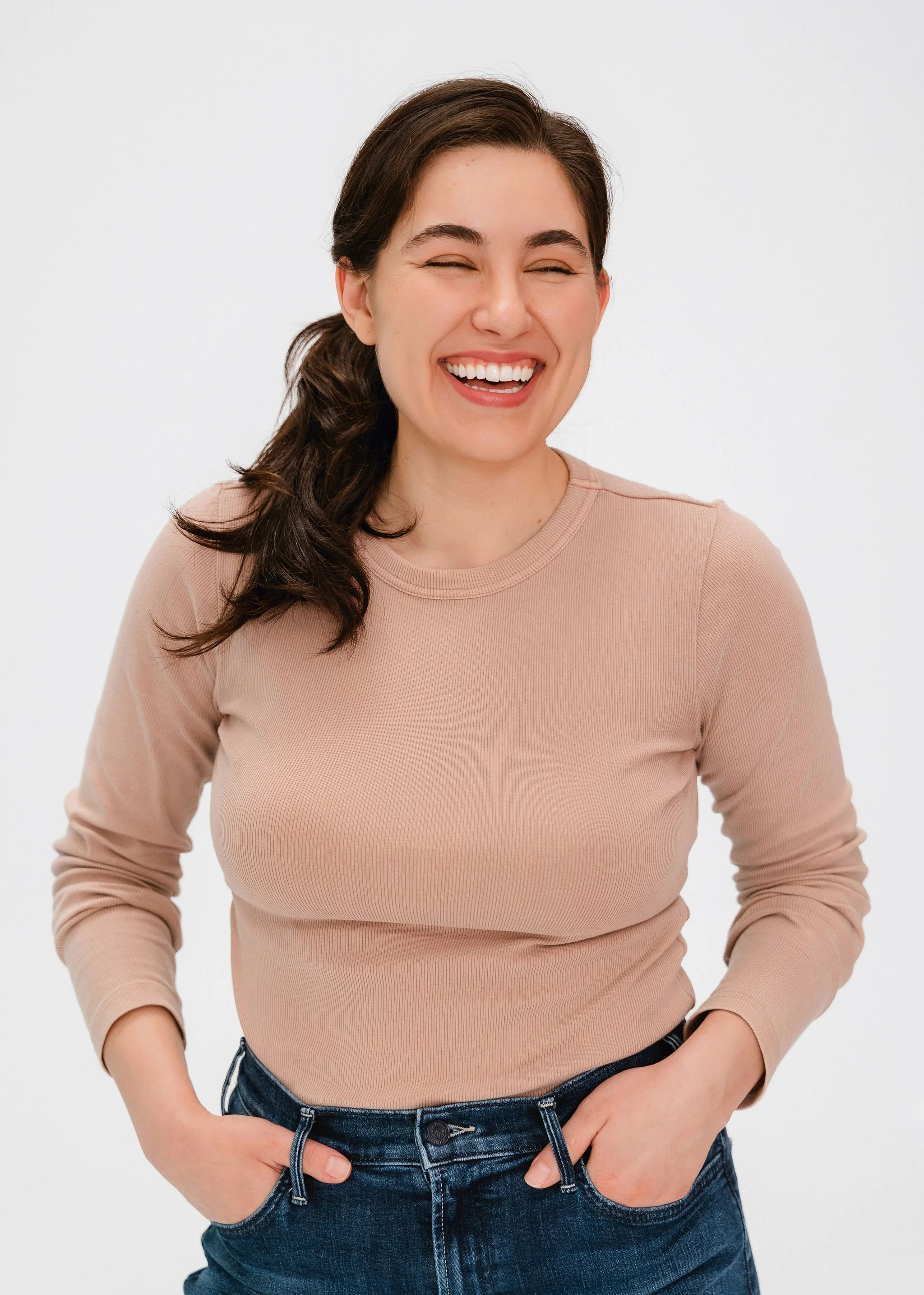 Monauar smiles with her eyes closed