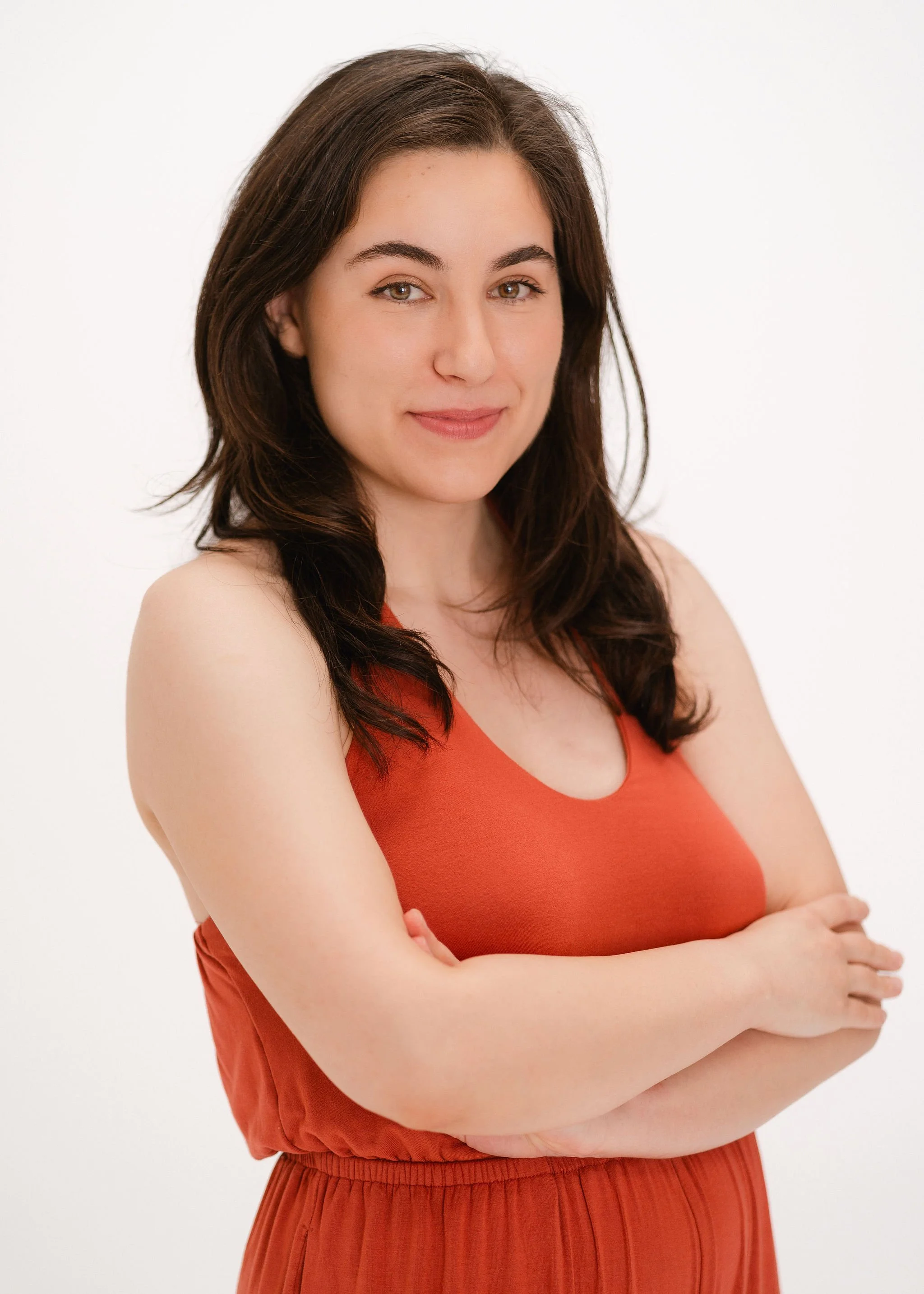 Monauar smiling with hands folded around her