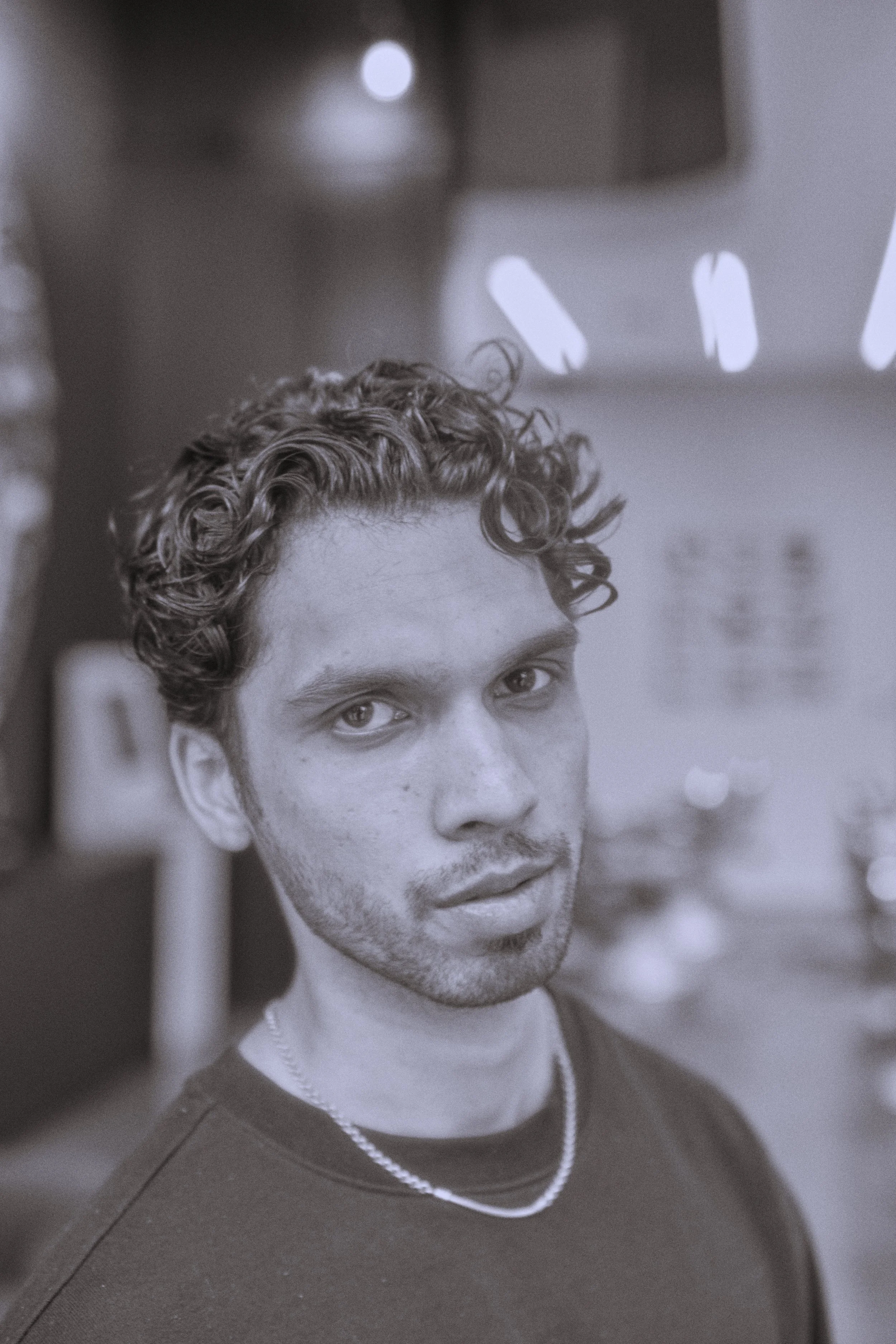 Medium-length men’s curly hairstyle — thick texture, defined curl pattern, tailored finish, LINEAGE Barber Atlanta, Best Barber Near me Atlanta Ga,Buckhead,Mid town, Chastain barber