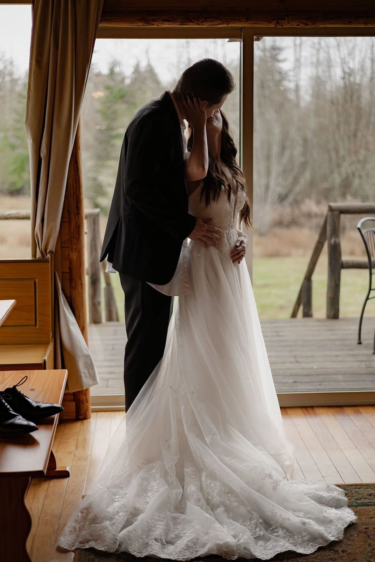 A couple in wedding attire embrace while getting dressed on the morning of their Olympic National Park elopement