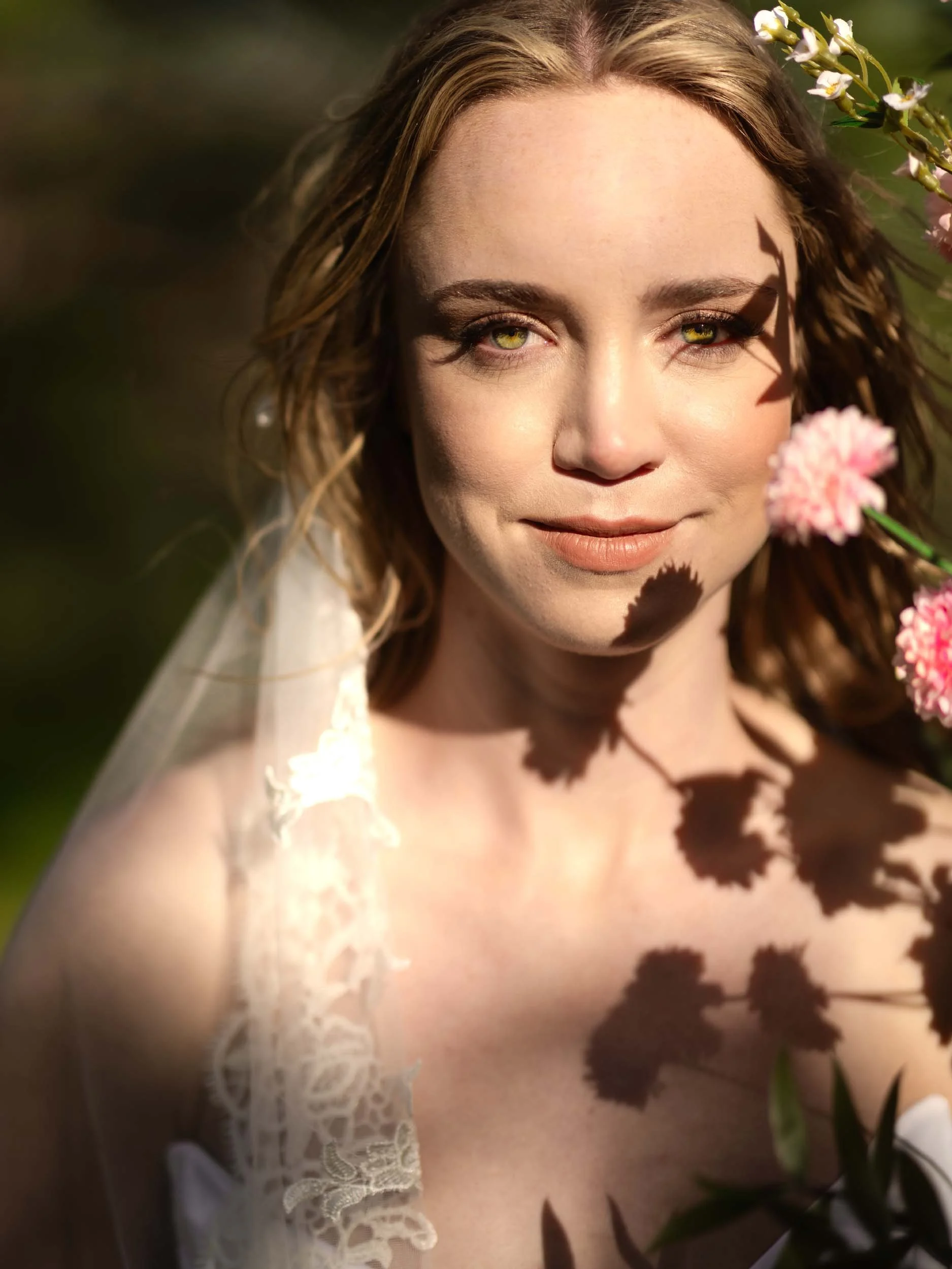 Editorial bride in harsh sunlight, artistically painted with shadows of flowers from a bridal arch at a wedding near Vancouver, WA.