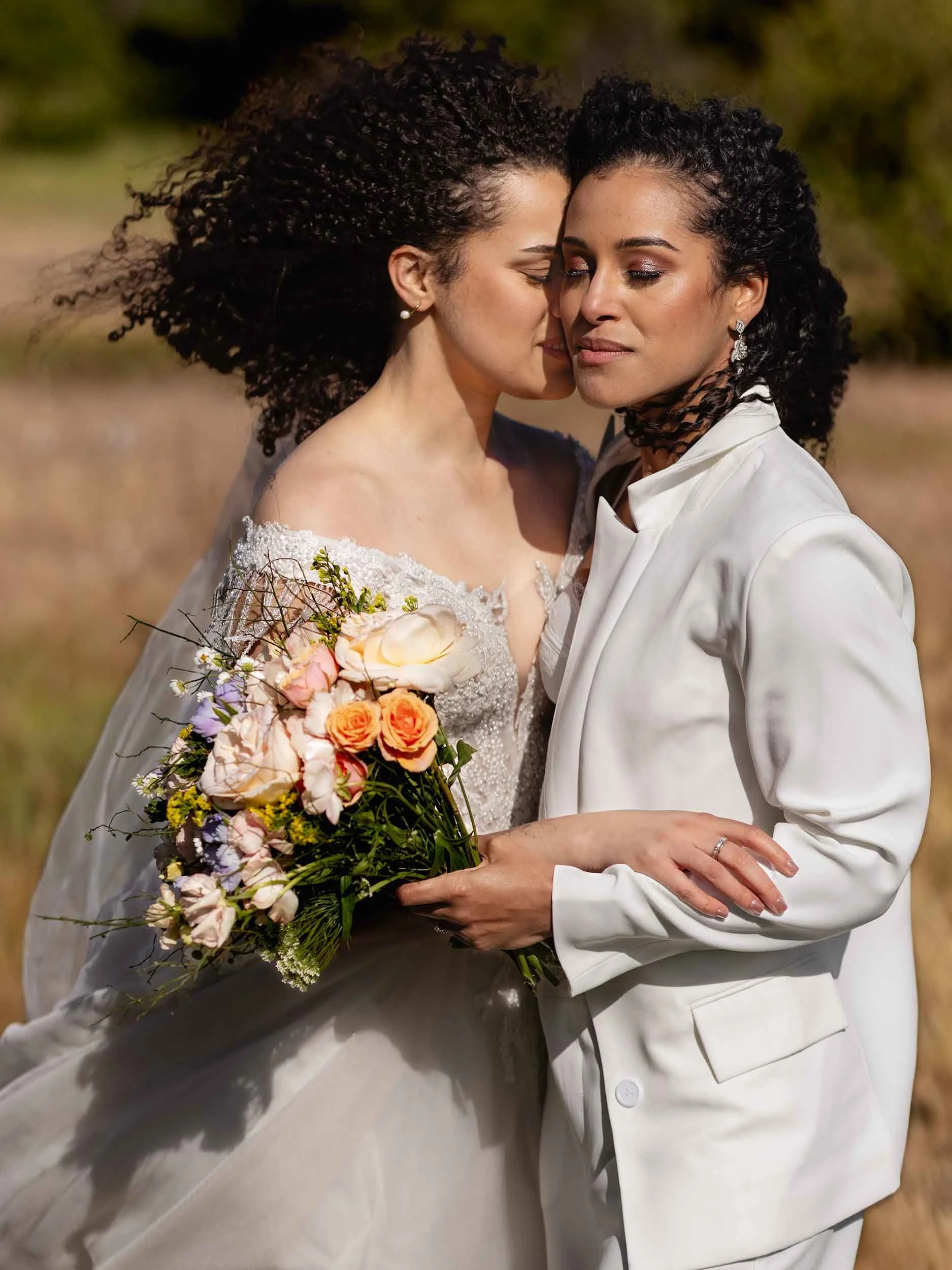 editorial lgbtq brides embrace at their Columbia River Gorge wedding in Washington.