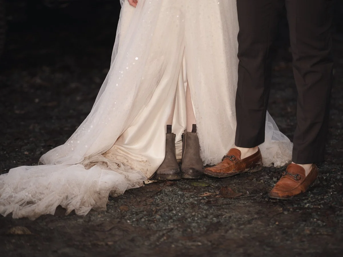 End of elopement close up shot of the bride and groom's muddy shoes and dress near Monroe, WA.