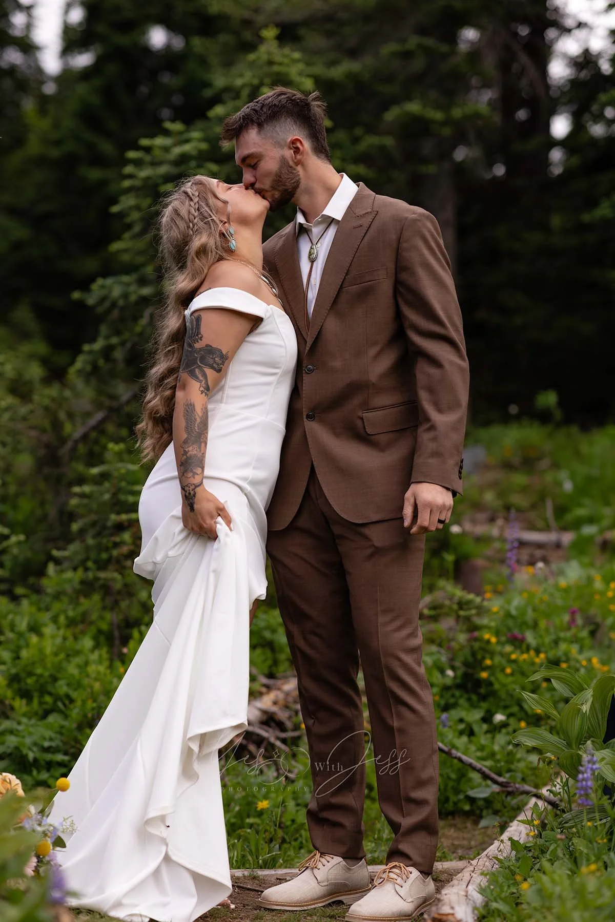 The bride and groom kiss during their elopement ceremony at Tipsoo Lake during wildflower season.