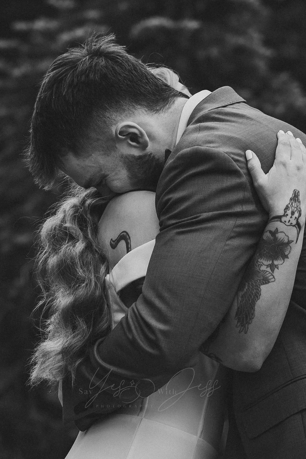 The bride and groom share an emotional hug during their elopement ceremony at Tipsoo Lake at Mount Rainier.