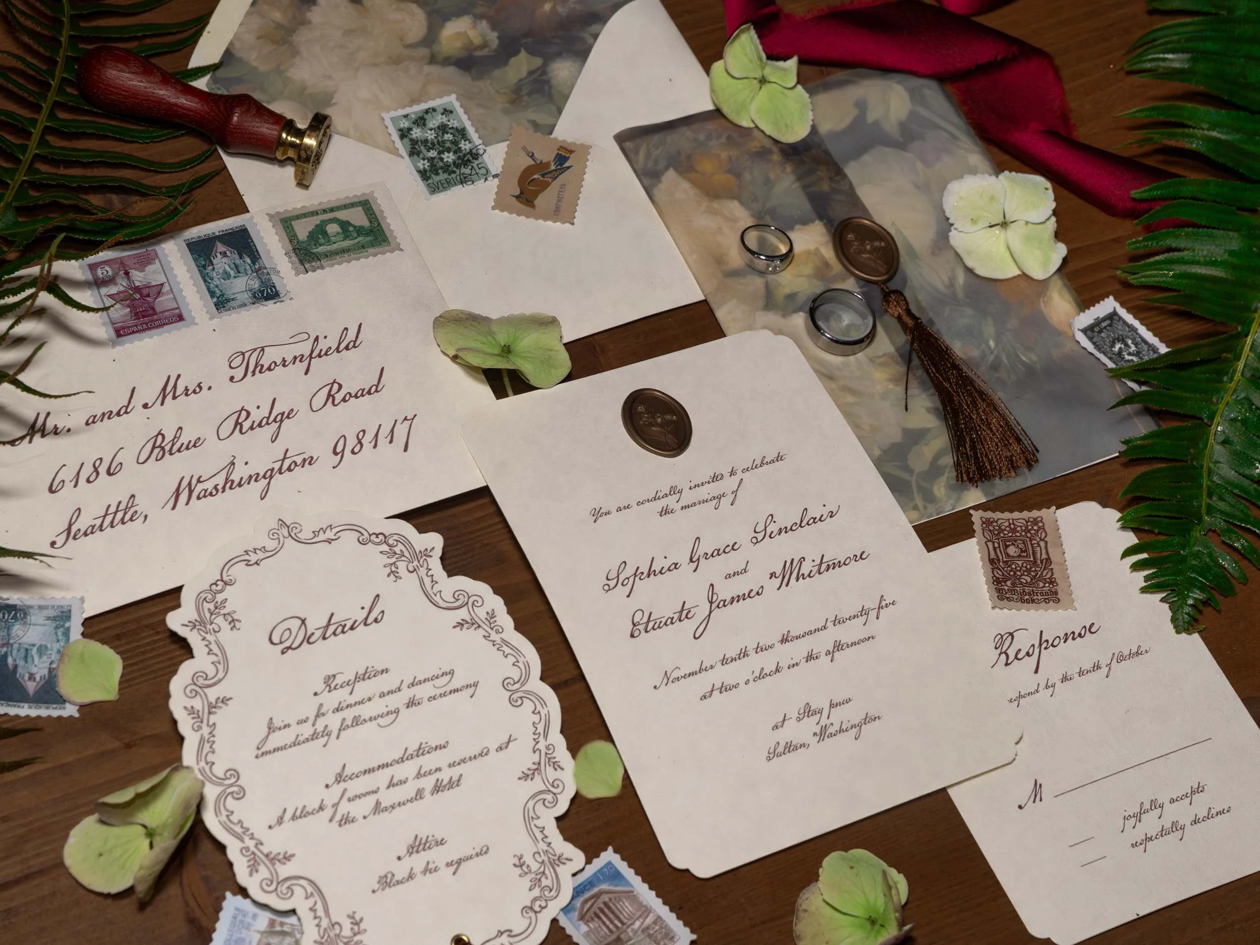 Flat lay at night at a Sultan, WA elopement with ferns, stationary, wedding rings and flower petals.