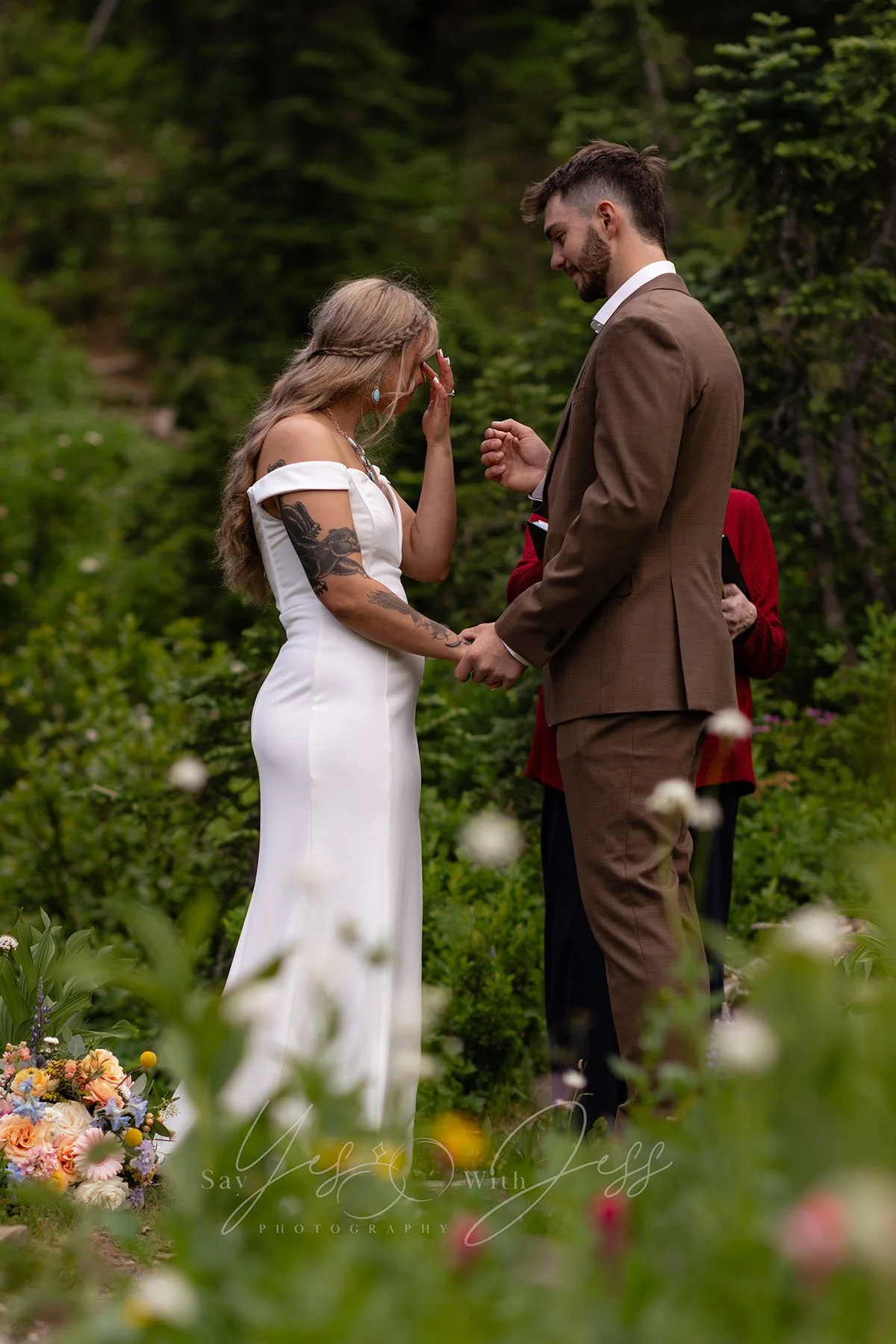 An emotional moment during an elopement ceremony at Tipsoo Lake during wildflower season.