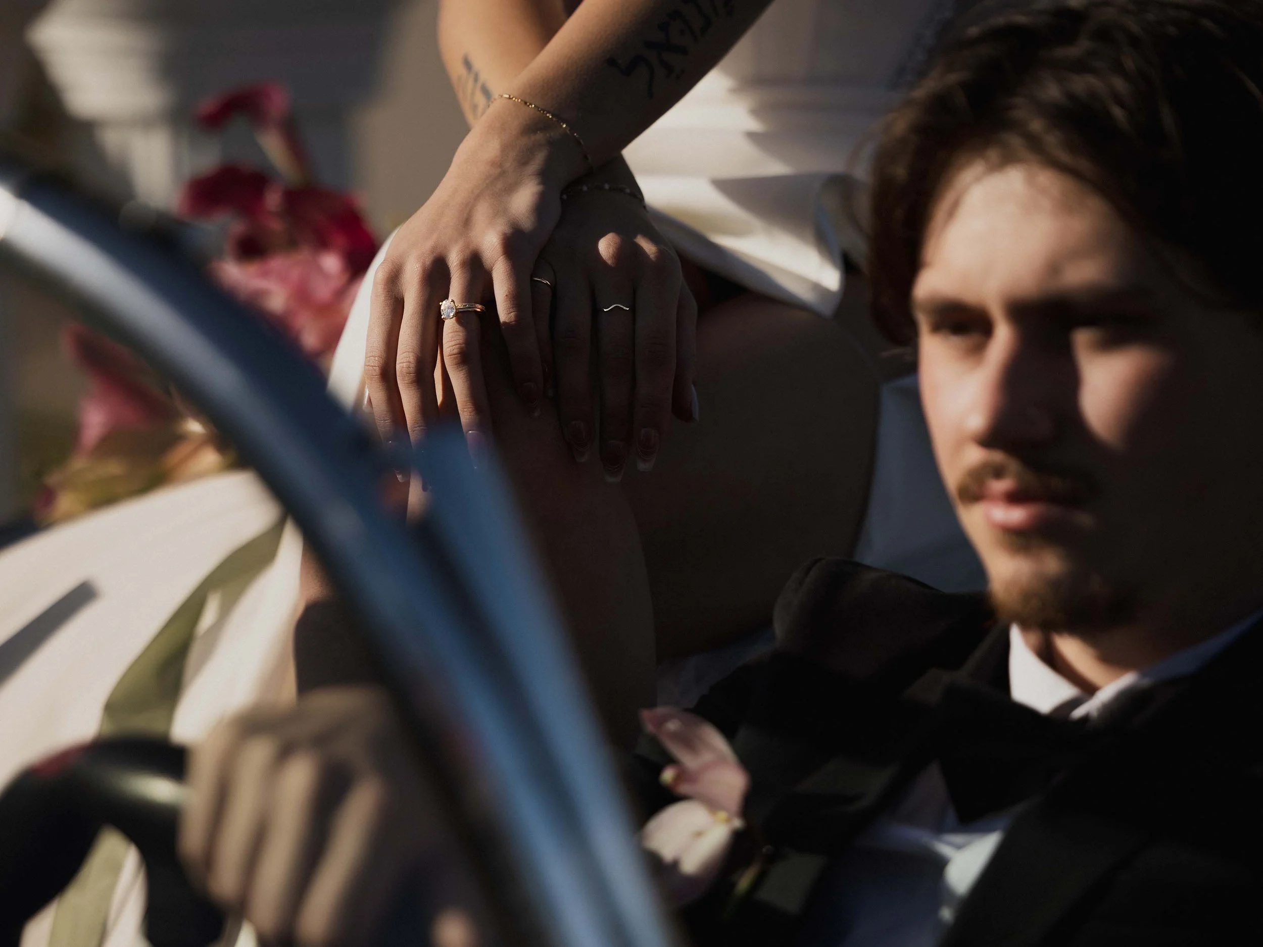 Editorial vintage corvette convertible  elopement with focus on wedding rings. 
