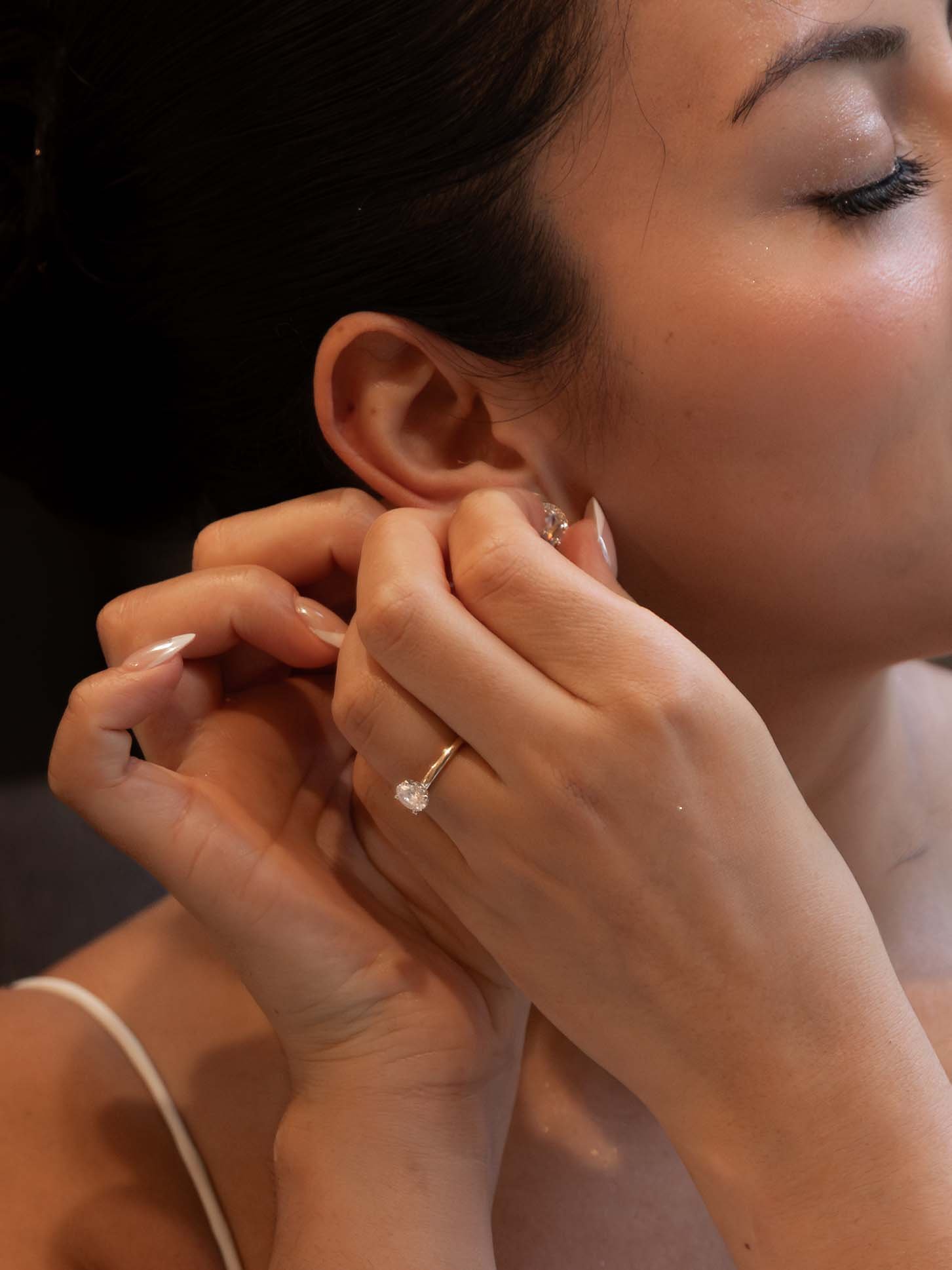 A bride puts on her earrings before her intimate ceremony near Mount Rainier.