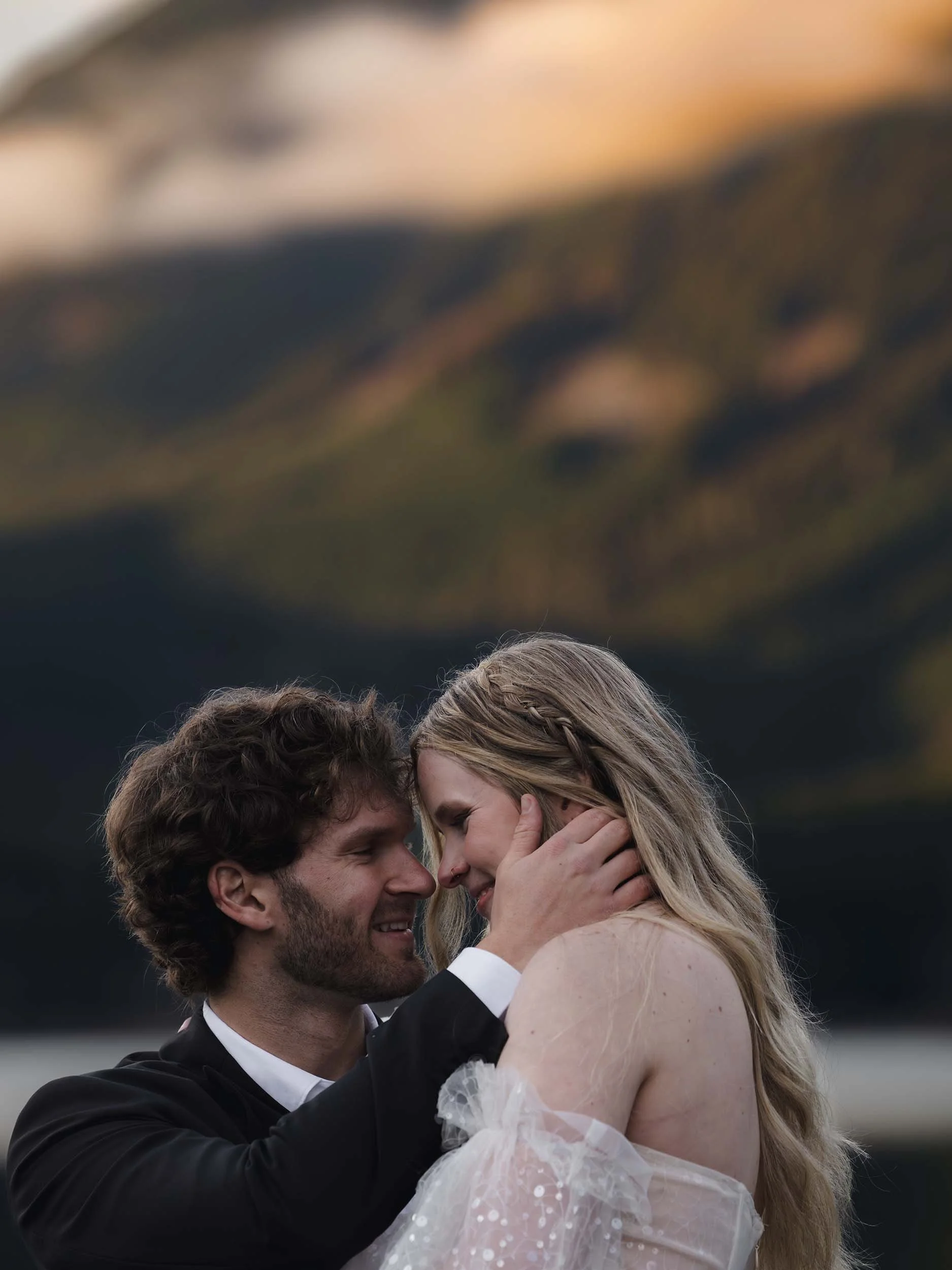 Couple embrace at sunset during a greider lake elopement
