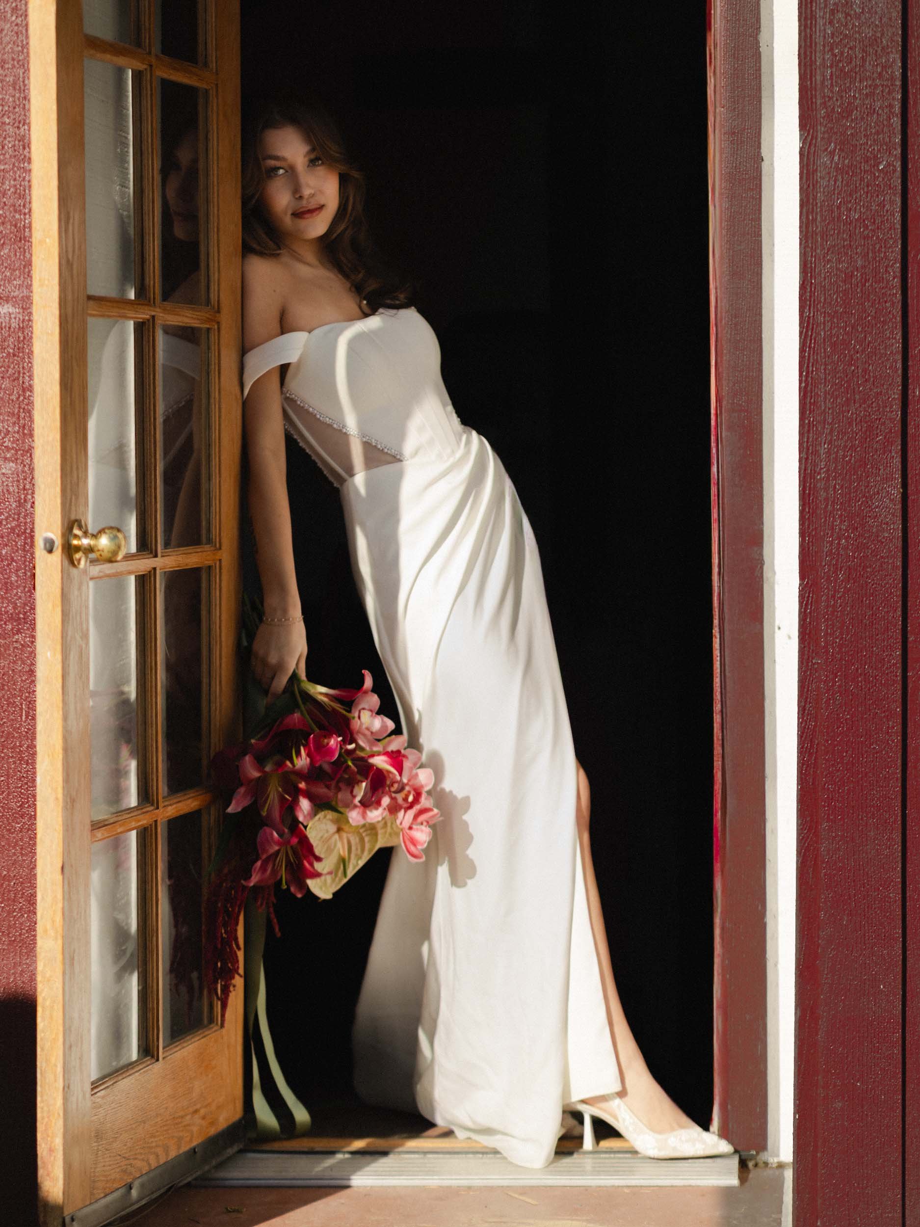 Editorial bride leaning against chapel door near Seattle
