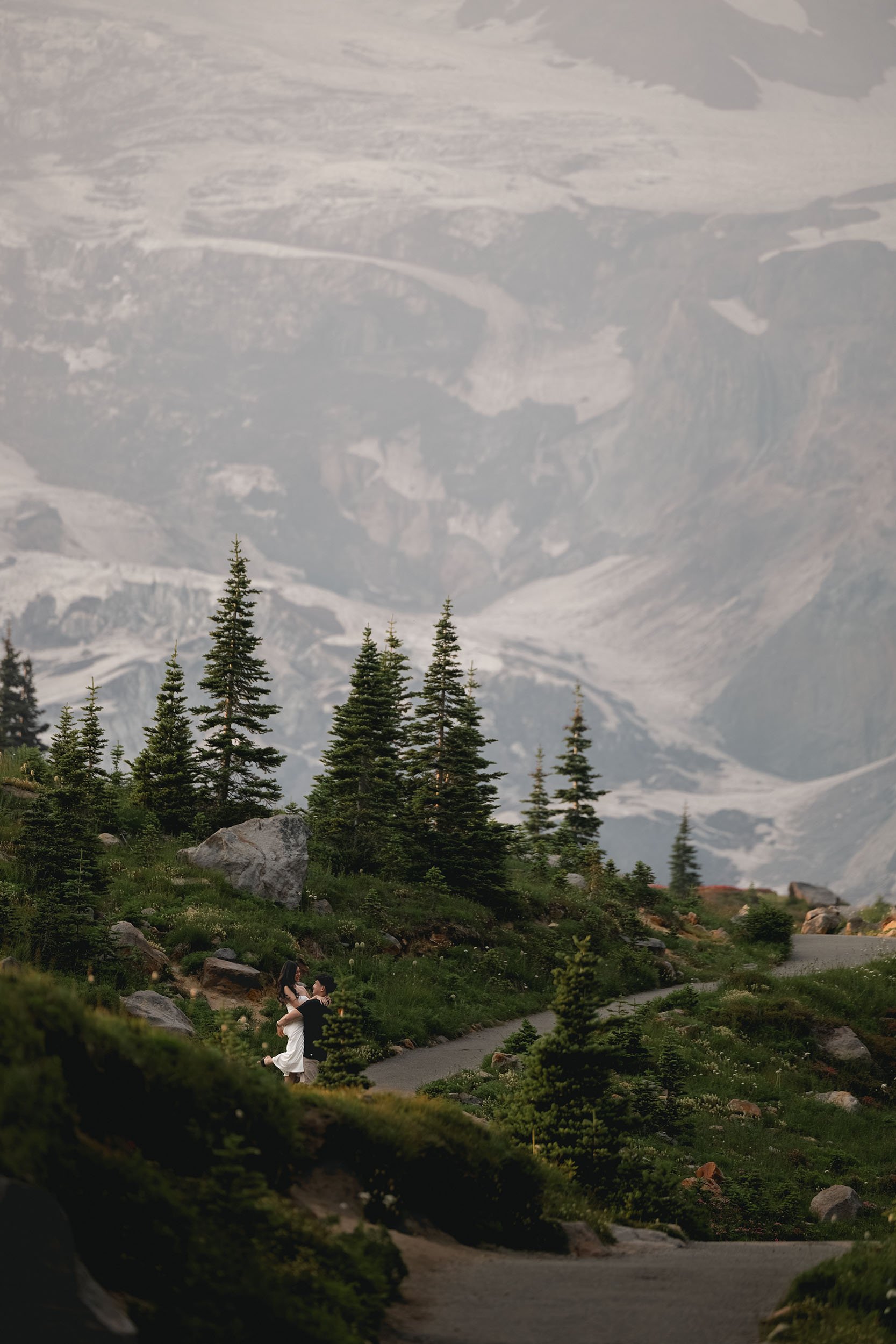 A man lifts his fiance during a Mount Rainier engagement session.