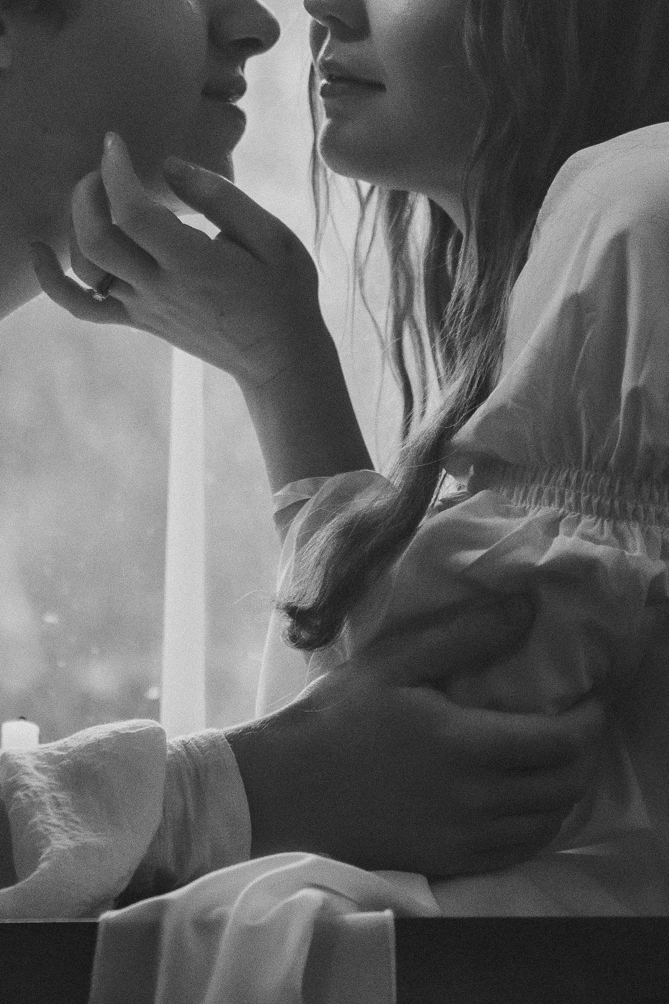 Heavy crop focus on a man and woman delicately touching each other in black and white during a storybook styled session  near Tacoma, Washington. 