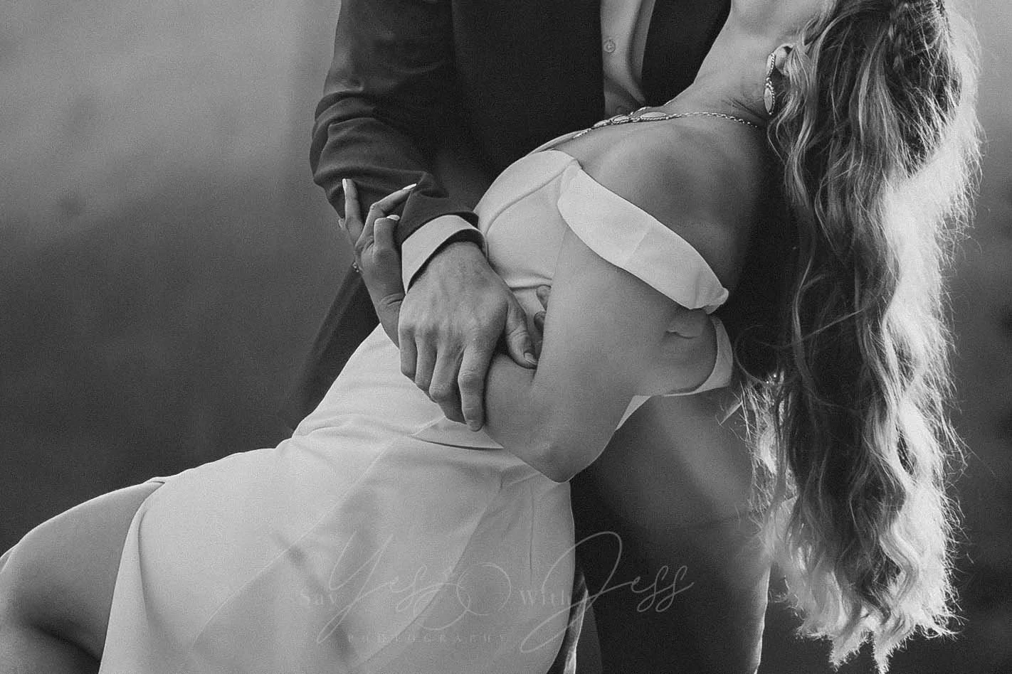 black and white heavy crop of a man dipping his bride at their Mount Rainier elopement.