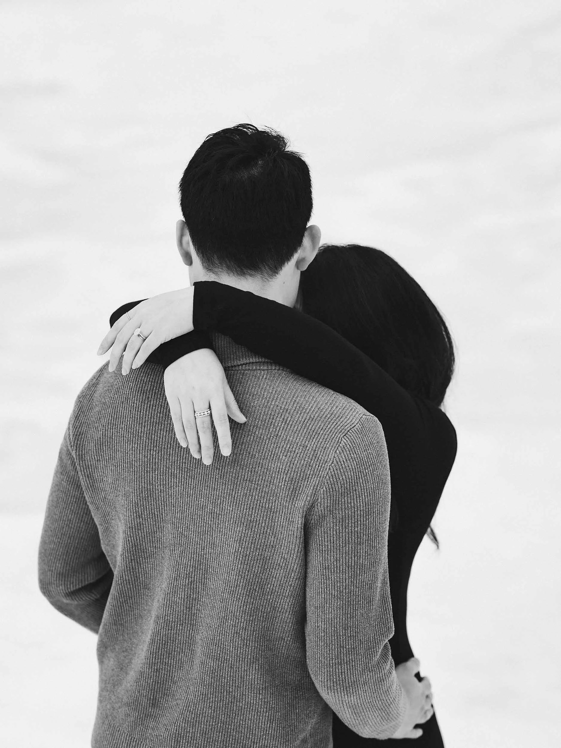 Her hands thrown around her husband ditorial black and white edit 