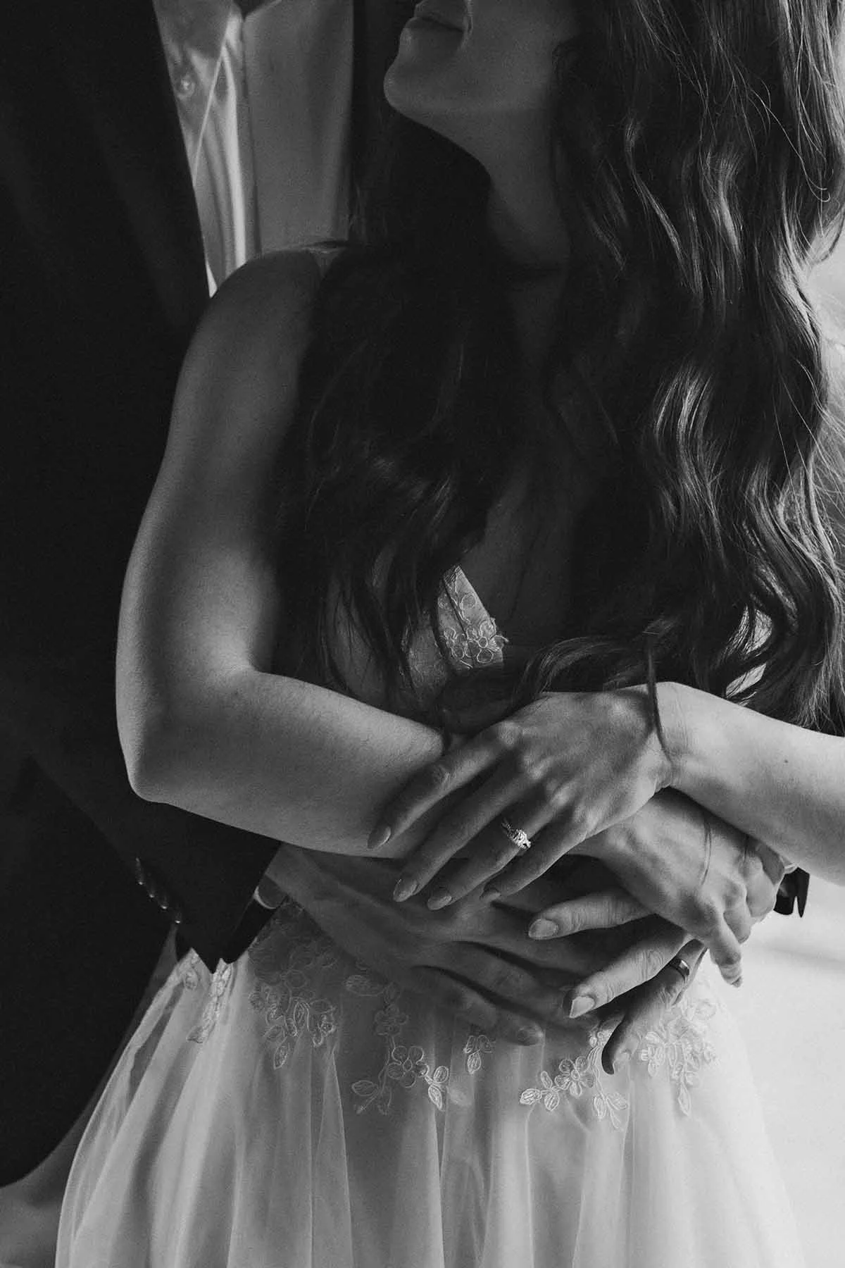 A couple in wedding attire embrace while getting dressed on the morning of their Olympic National Park elopement