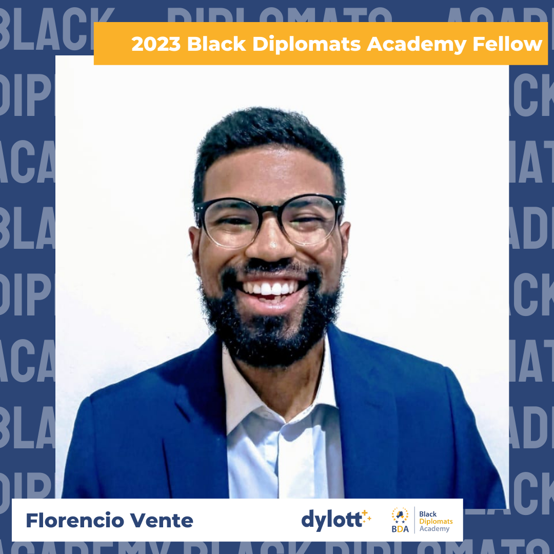 Portrait of Florencio Vente, smiling, wearing glasses and a blue suit, with text indicating he is a 2023 Black Diplomats Academy Fellow.