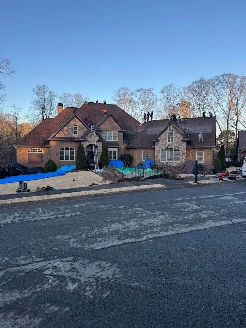 Big League Roofing crew completing a full roof replacement on a large brick home in North Georgia