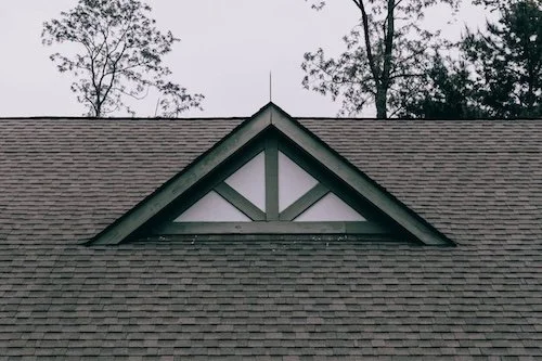 Newly installed roof on a white residential home by Big League Roofing