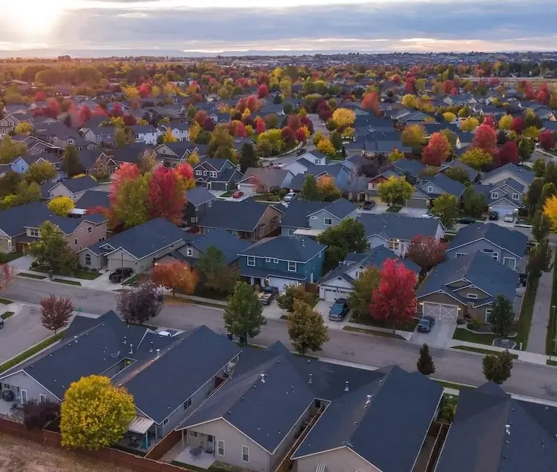 Aerial view of a residential neighborhood with asphalt shingle roofs served by Big League Roofing in North Georgia
