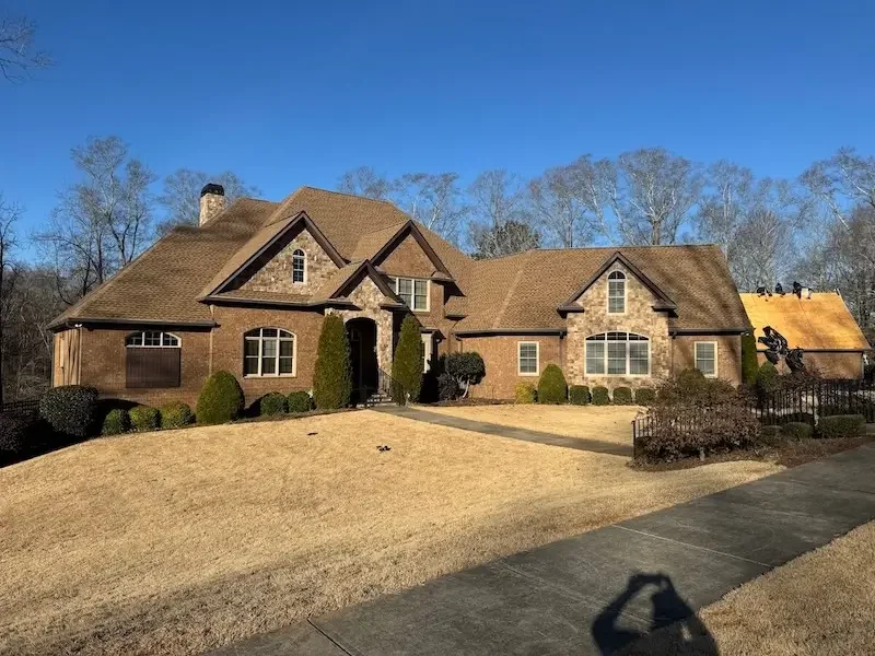 Completed roof replacement on a luxury brick home in North Georgia by Big League Roofing