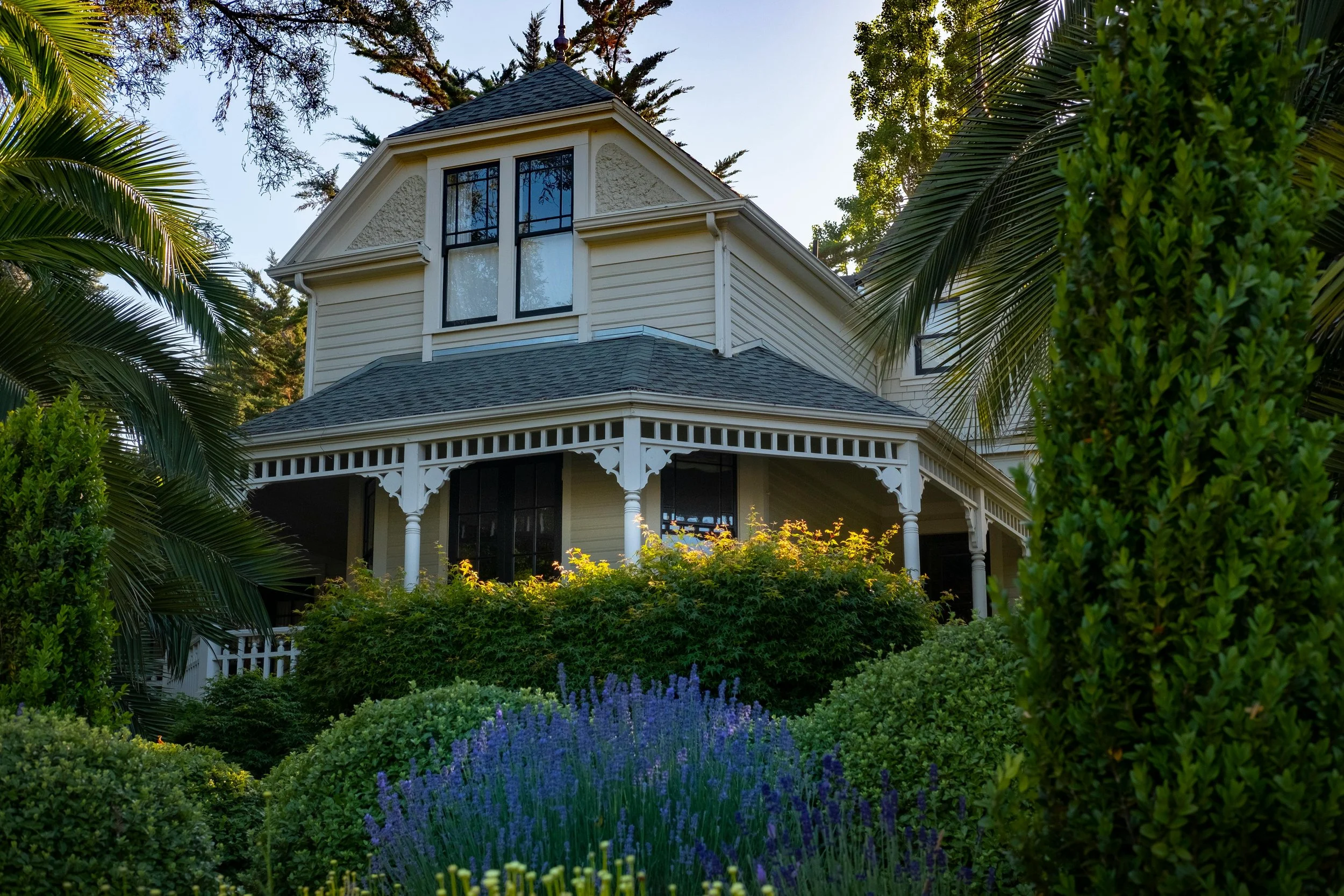 Image of a Victorian house front with a porch and ornate trim