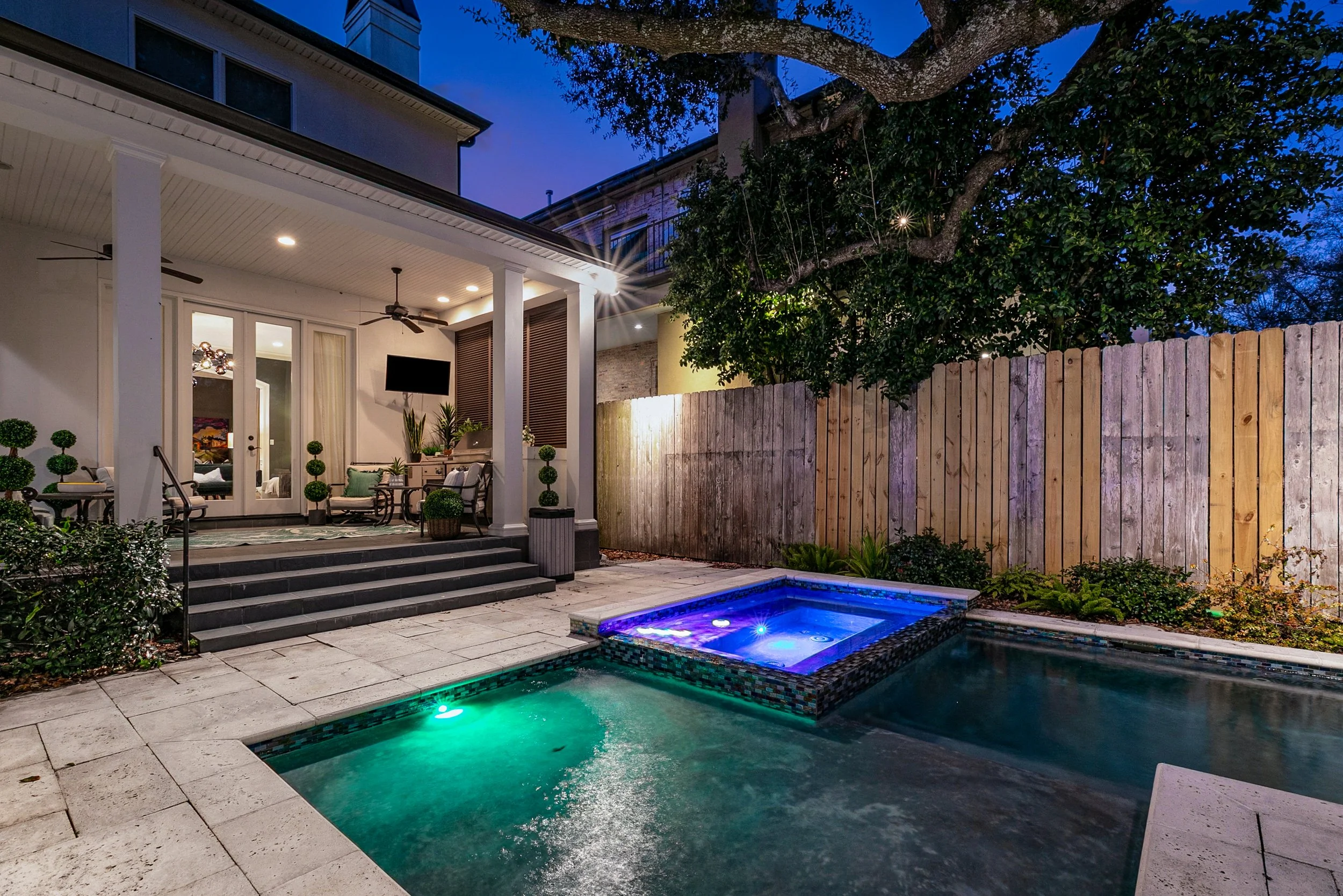 Aimee (Amay) Curole, Top Realtor in Metairie, Luxury Outdoor Living at night showcasing the Viking Outdoor Kitchen, LED lighted saltwater, heated pool in Metairie, LA, Luxury Listing Expert-Aimee (Amay) Curole.