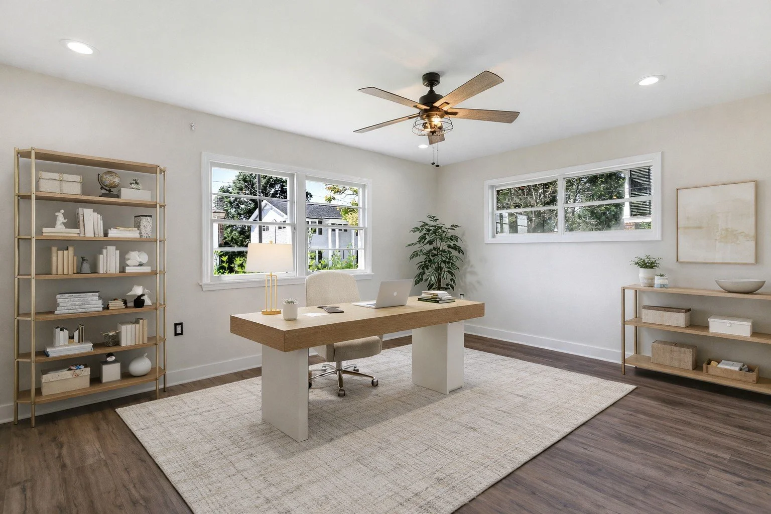 Virtually Staged Listing pictures with Aimee (Amay) Curole, Top Realtor in Metairie, 23 Realty.  Bright home office with a wooden desk, beige chair, large windows, neutral decor, and minimalistic shelves with decor items.