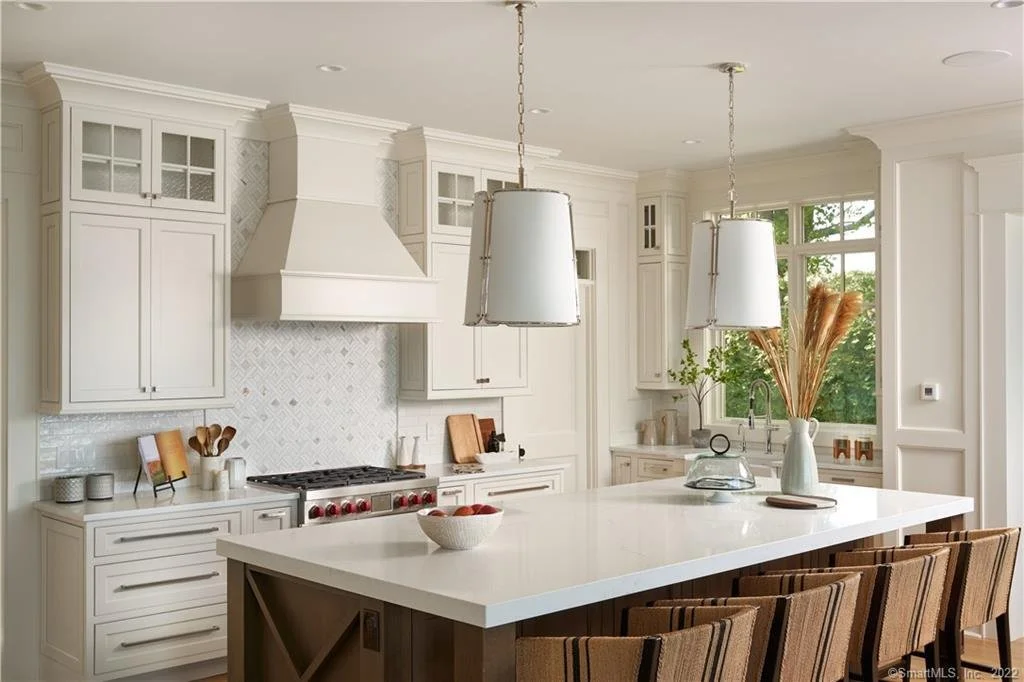 Coastal Essex CT kitchen with creamy inset cabinetry, dark island and Wolf range