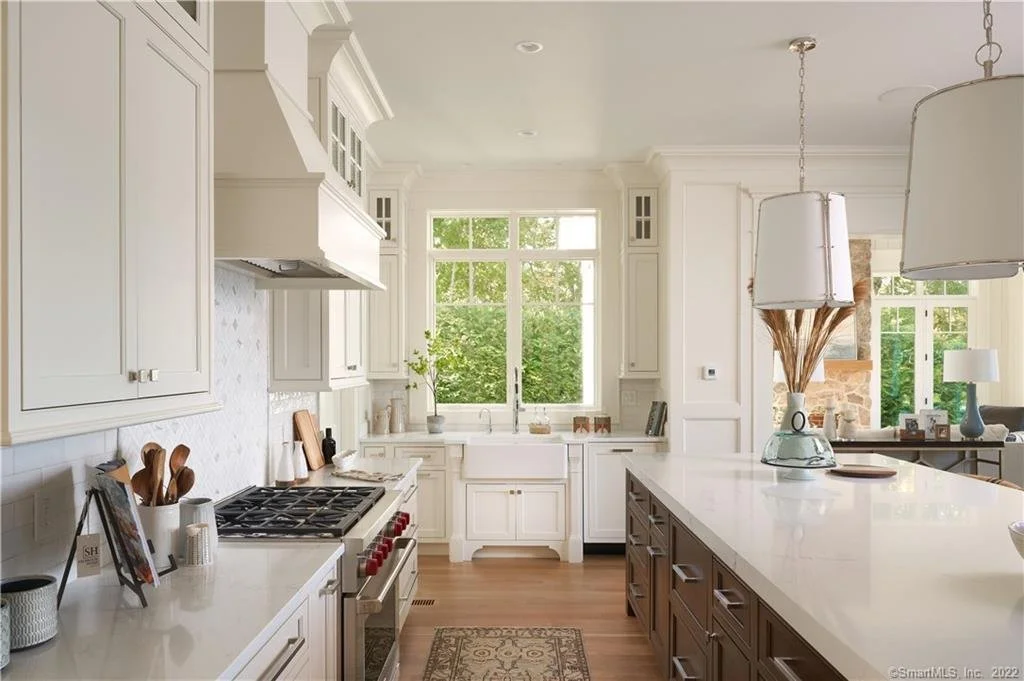 Farmhouse sink and custom perimeter cabinetry in an Essex CT coastal kitchen