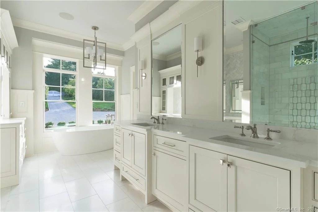 Custom white bathroom vanities in an Essex CT coastal home