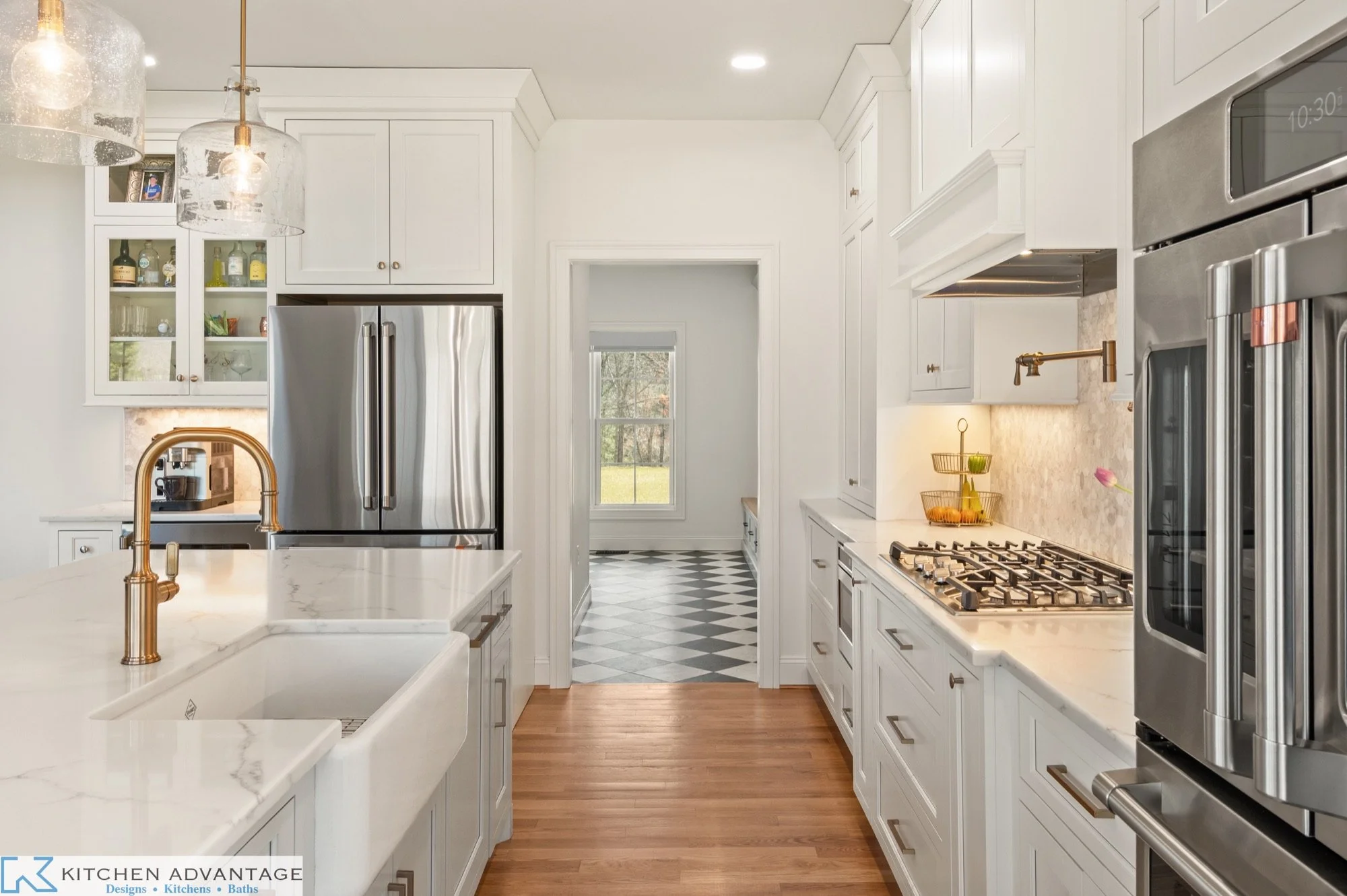 White inset kitchen cabinetry and an island sink in the East Haddam home