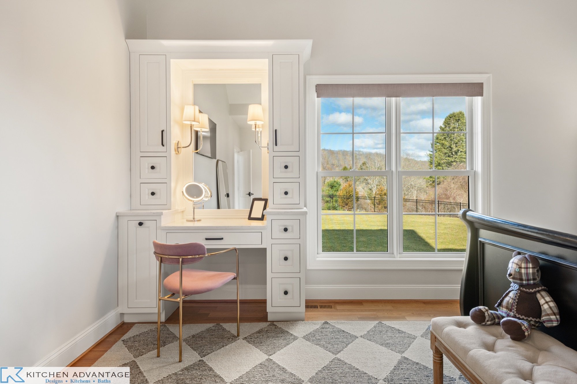 Primary bedroom makeup vanity framed by tall inset cabinets in East Haddam