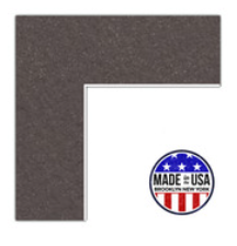 Close-up of a L-shaped piece of asphalt with a small white background.