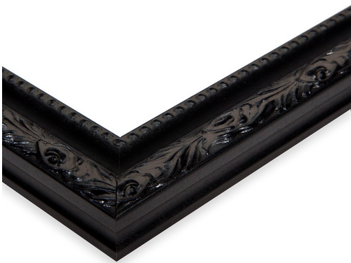 Close-up of a black decorative picture frame with intricate carved details.